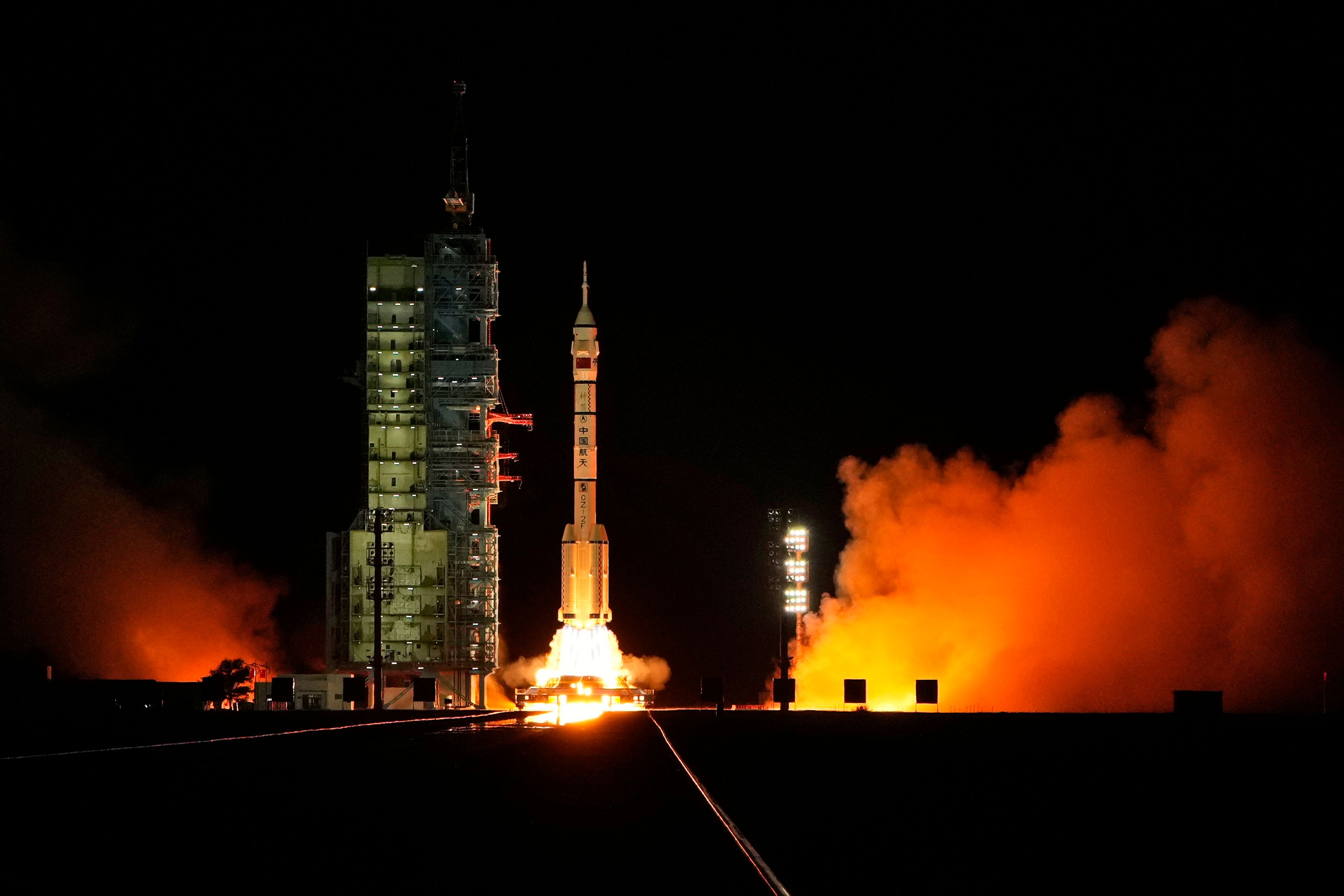 A Long March rocket with a Shenzhou-19 spacecraft atop takes off from the Jiuquan Satellite Launch Center in Jiuquan, northwestern China in the early hours of Wednesday, Oct. 30, 2024. (AP Photo/Ng Han Guan)