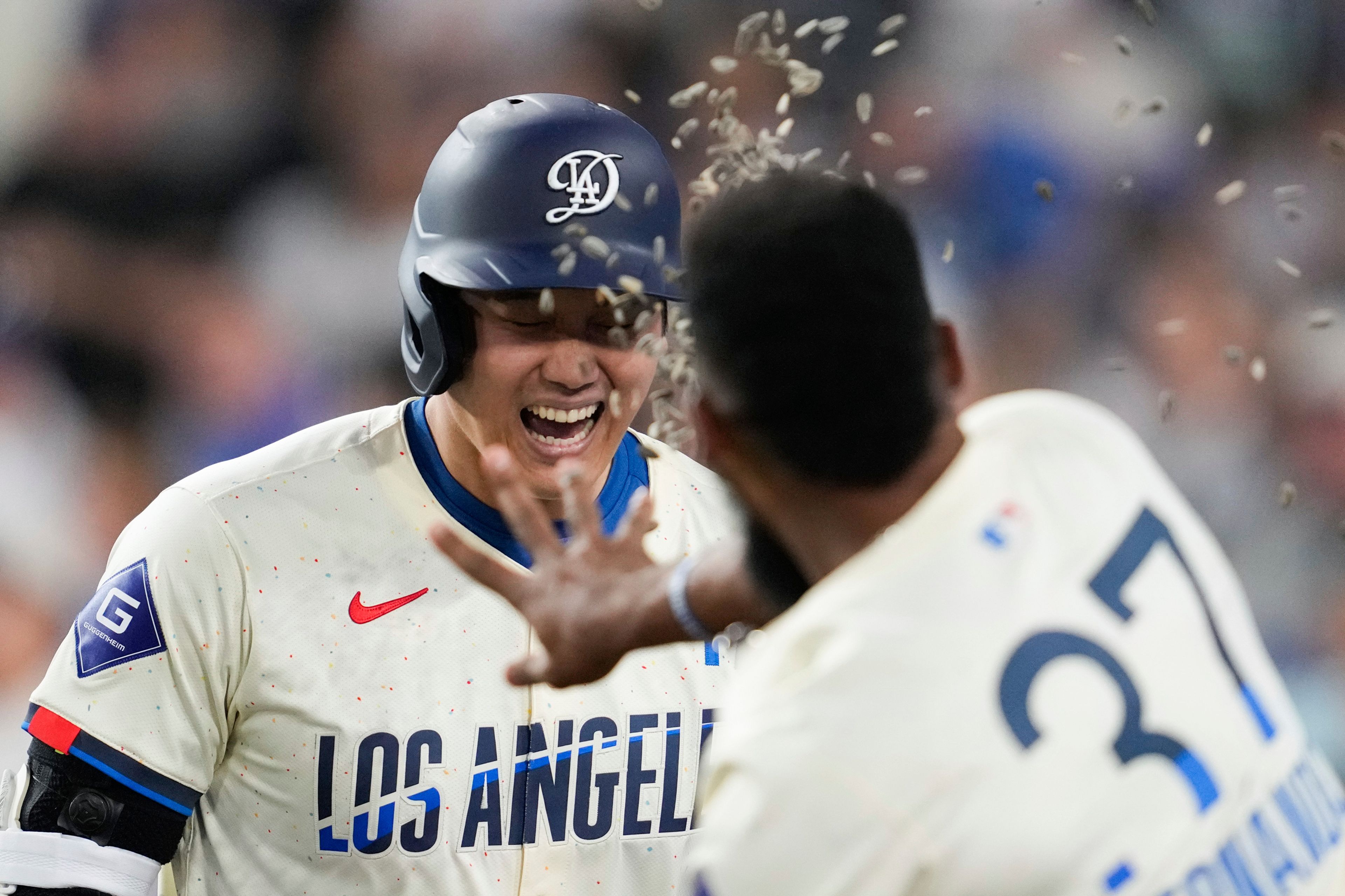 Los Angeles Dodgers designated hitter Shohei Ohtani (17) celebrates with Teoscar Hernández (37) after hitting a home run during the fifth inning of a baseball game against the Tampa Bay Rays in Los Angeles, Saturday, Aug. 24, 2024. Miguel Rojas also scored. (AP Photo/Ashley Landis)