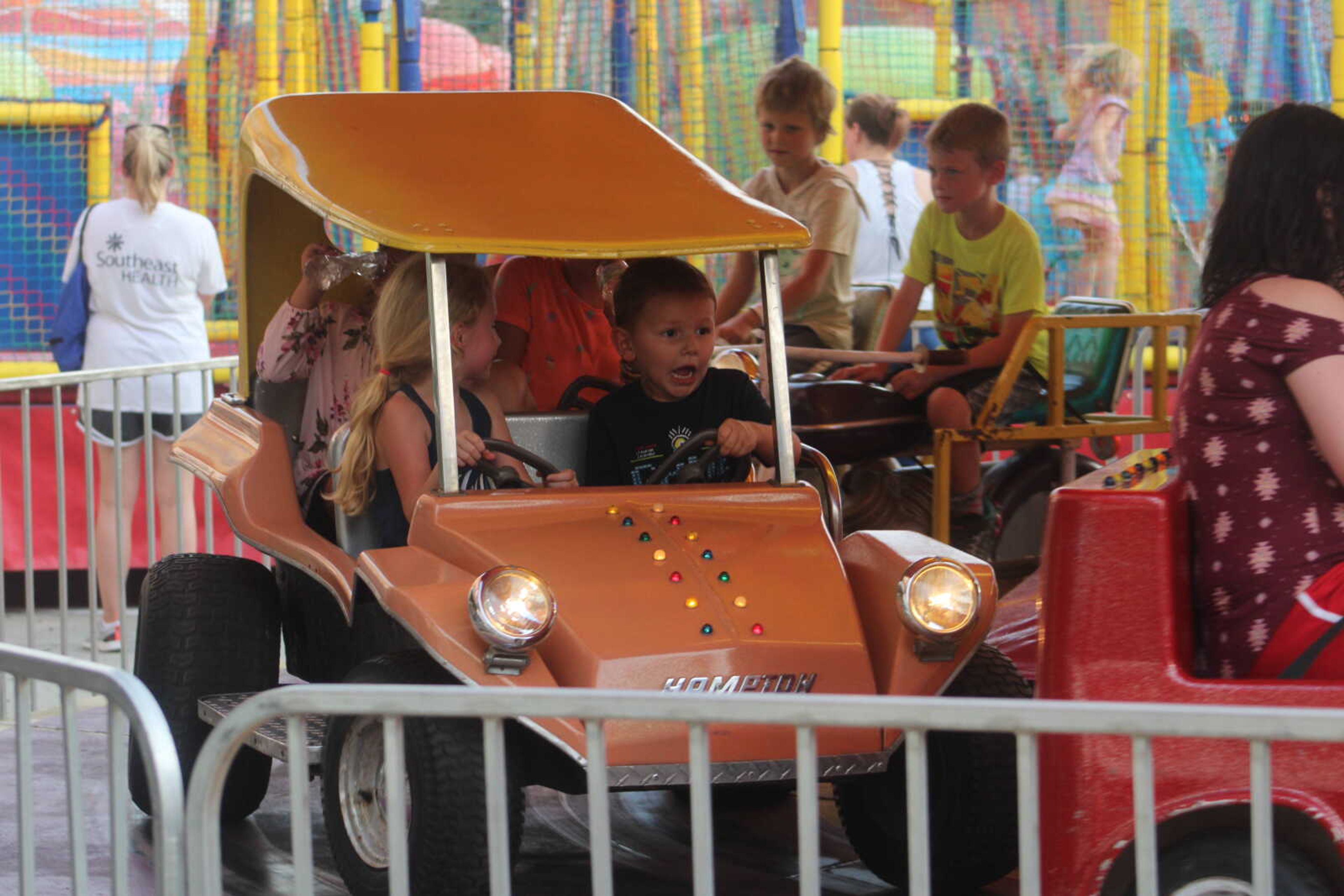 Children ride one of many rides at Jackson Homecomers on Wednesday, July 28, 2021, in Uptown Jackson.