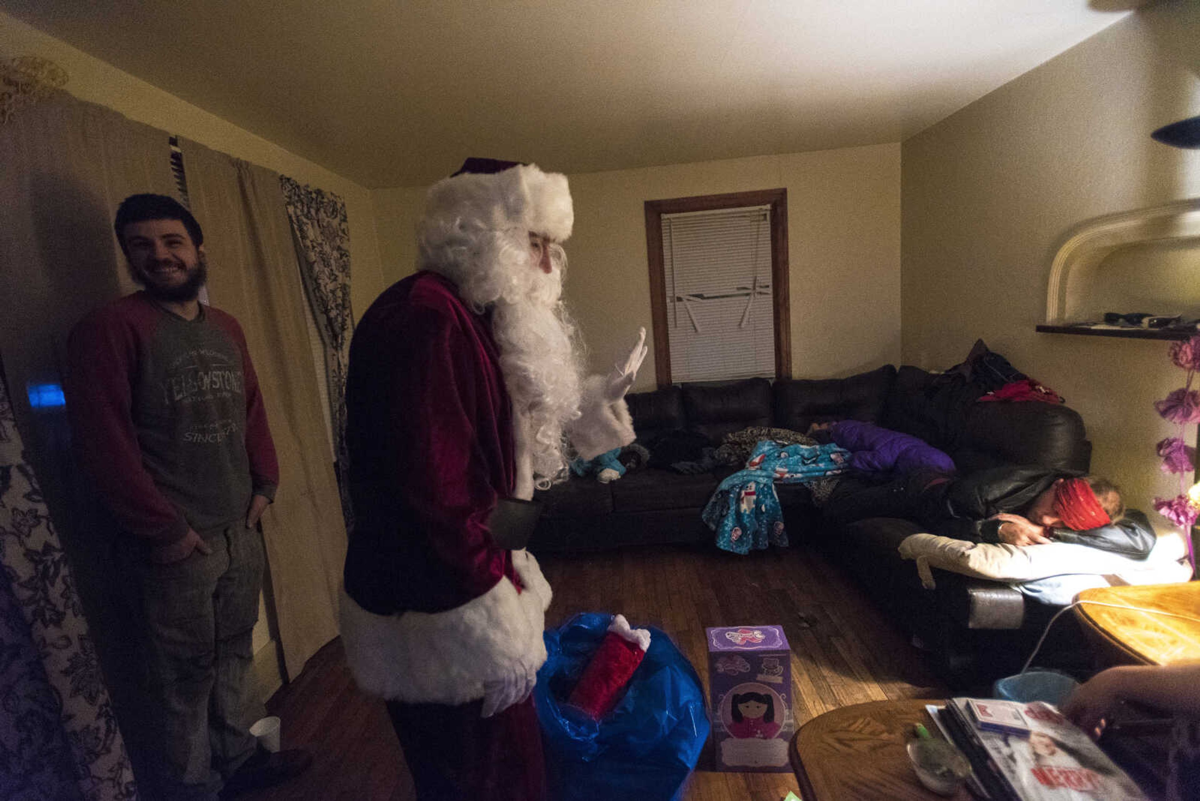 Charlie Wirtle as Santa deliveries presents to kids during the Jaycee Toybox delivery on Thursday, Dec. 22, 2016, in Cape Girardeau.