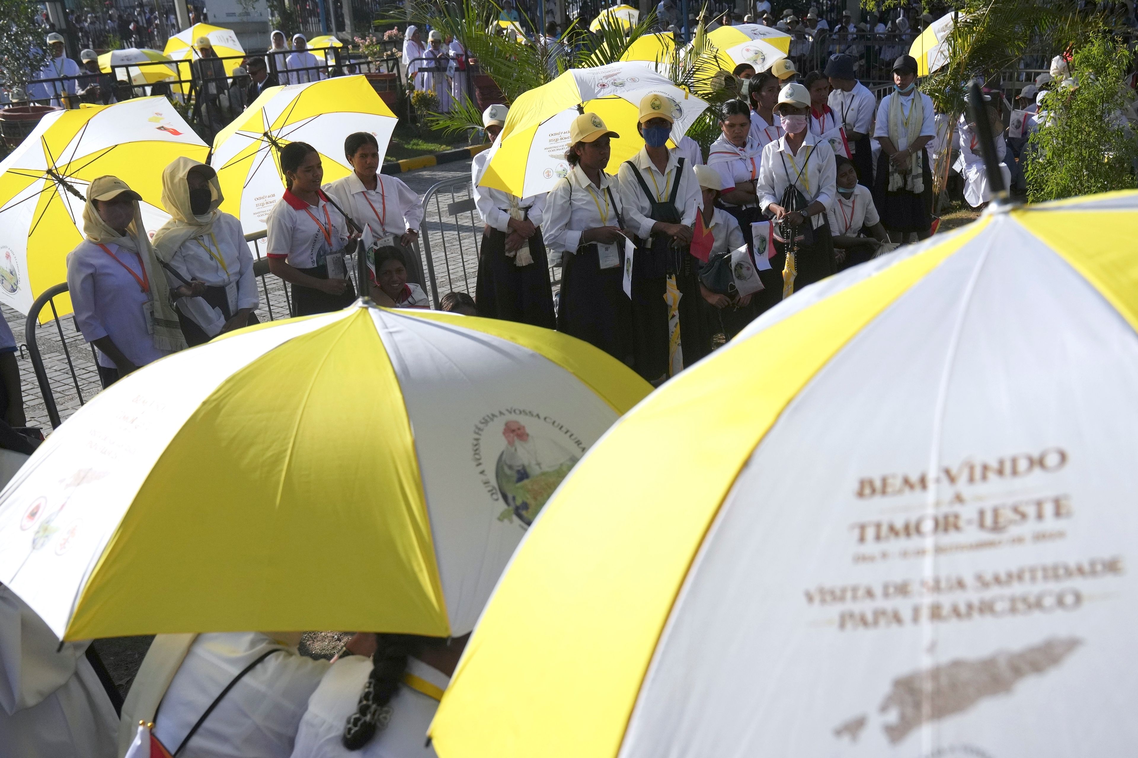 People wait for Pope Francis visiting to children with disabilities of the Irmas Alma School in Dili, East Timor, Tuesday, Sept. 10, 2024. (AP Photo/Dita Alangkara)