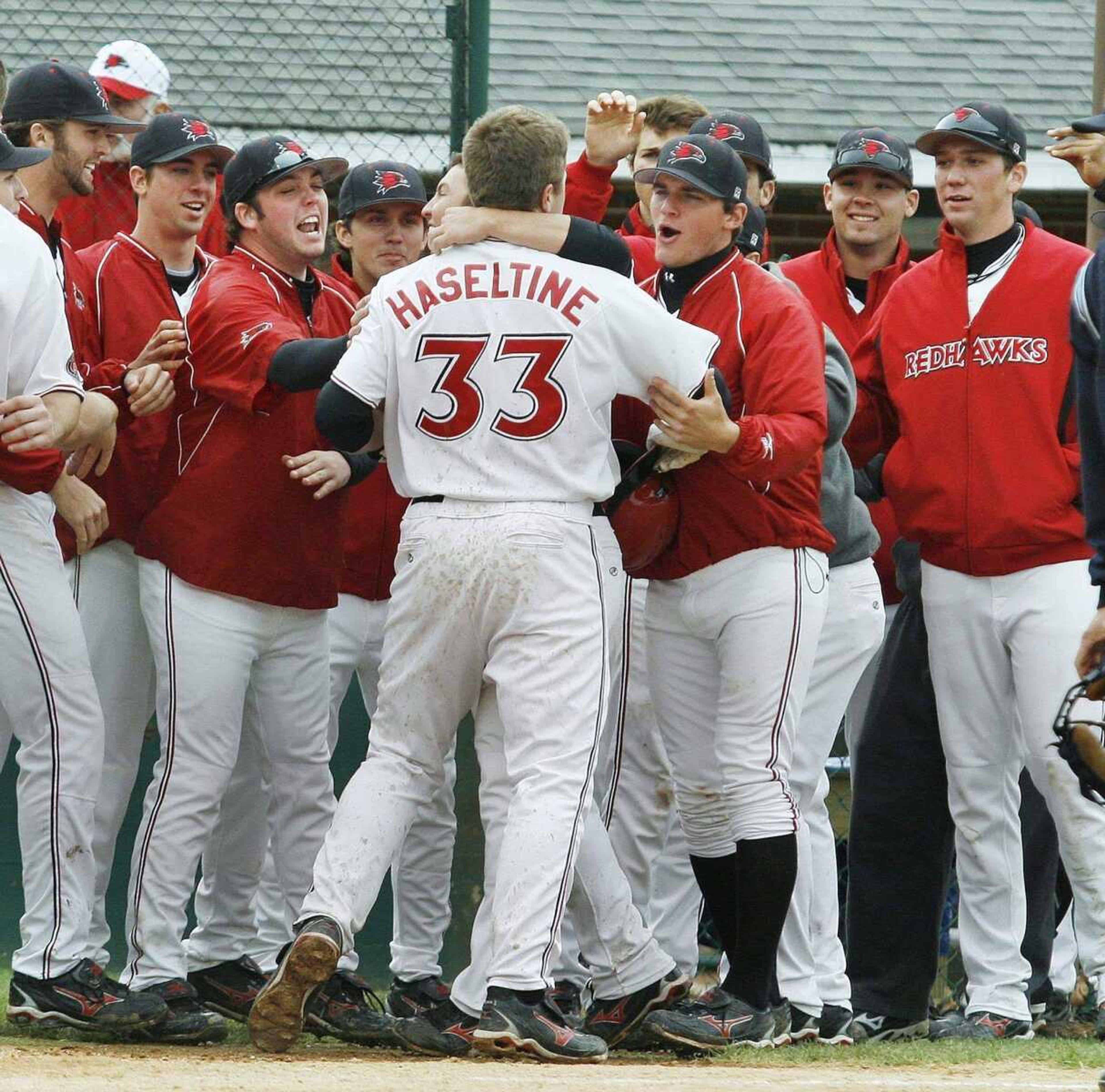 ELIZABETH DODD ~ edoddsemissourian.com<br>Southeast's Louie Haseltine celebrates with his teammates after hitting a home run during the first game of a doubleheader Saturday.