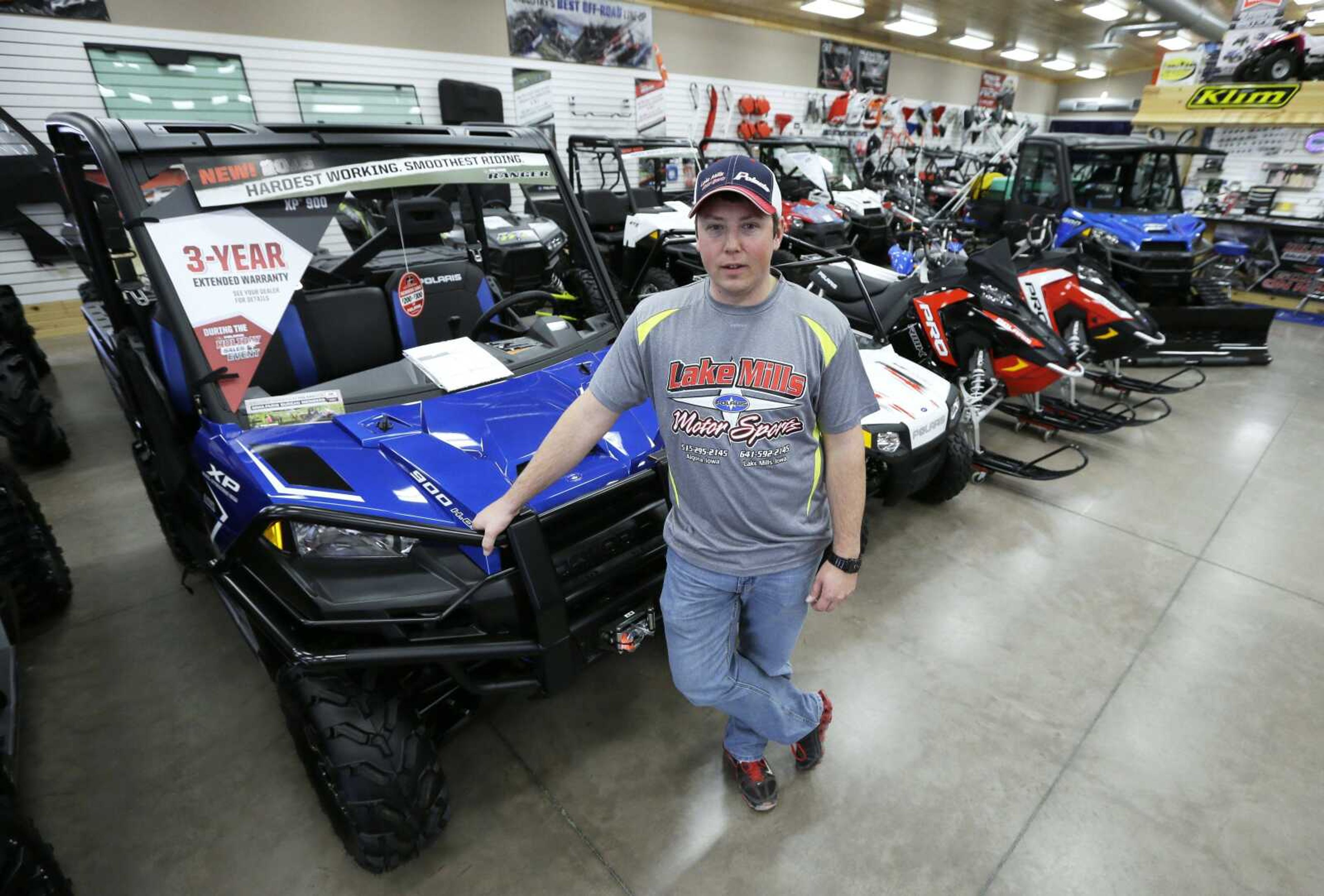 Michael Rygh stands near all-terrain vehicles at his dealership Dec. 16 in Algona, Iowa. Small towns across the nation are under pressure from riders who want to go wherever they please. (Charlie Neibergall ~ Associated Press)