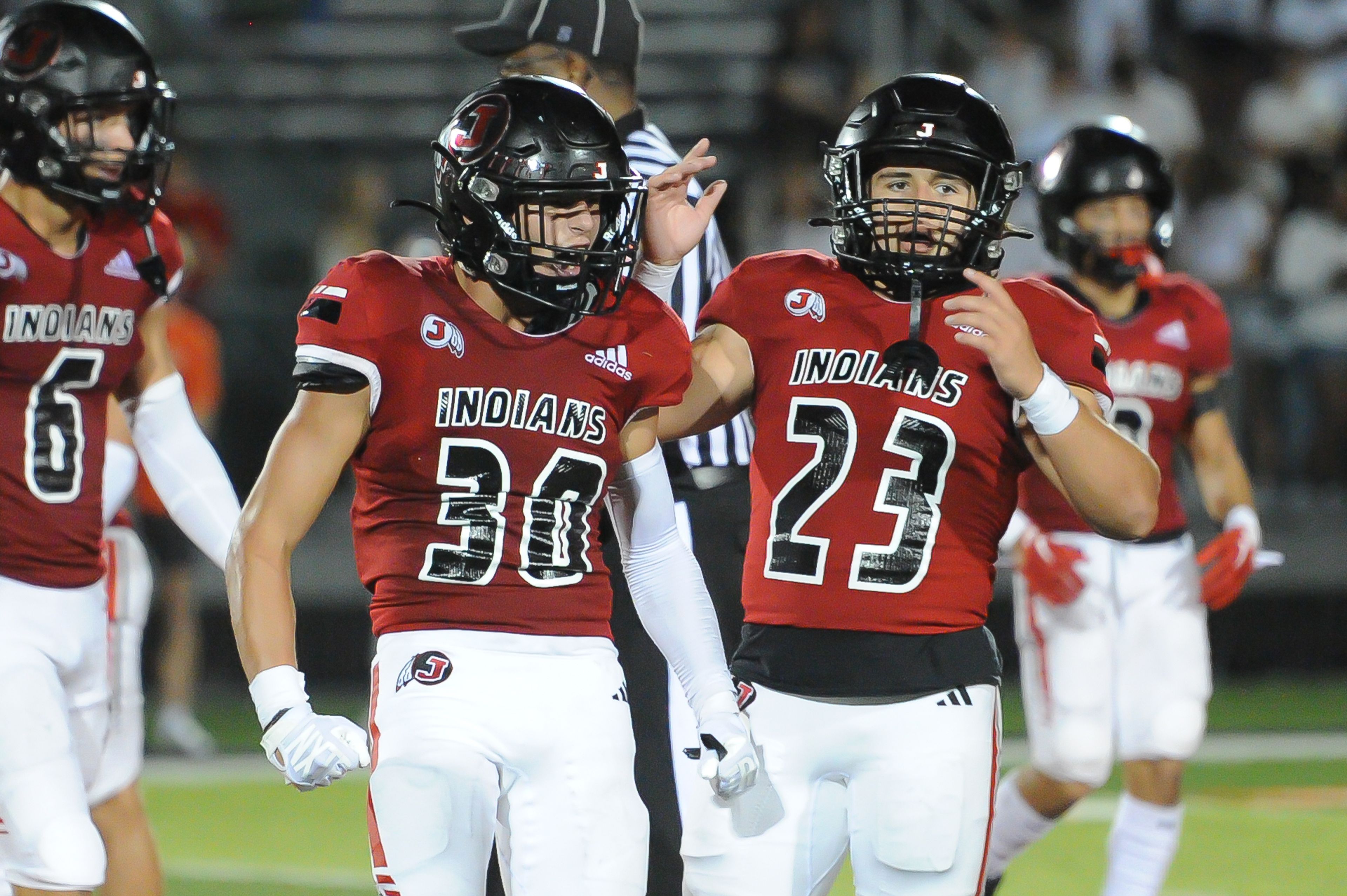 Jackson's Lukas Cox (left-center) celebrates a defensive stop during a Saturday, September 14, 2024 game between the Edwardsville Tigers and the Jackson Indians at Edwardsville High School in Edwardsville, Ill. Edwardsville defeated Jackson, 41-7.