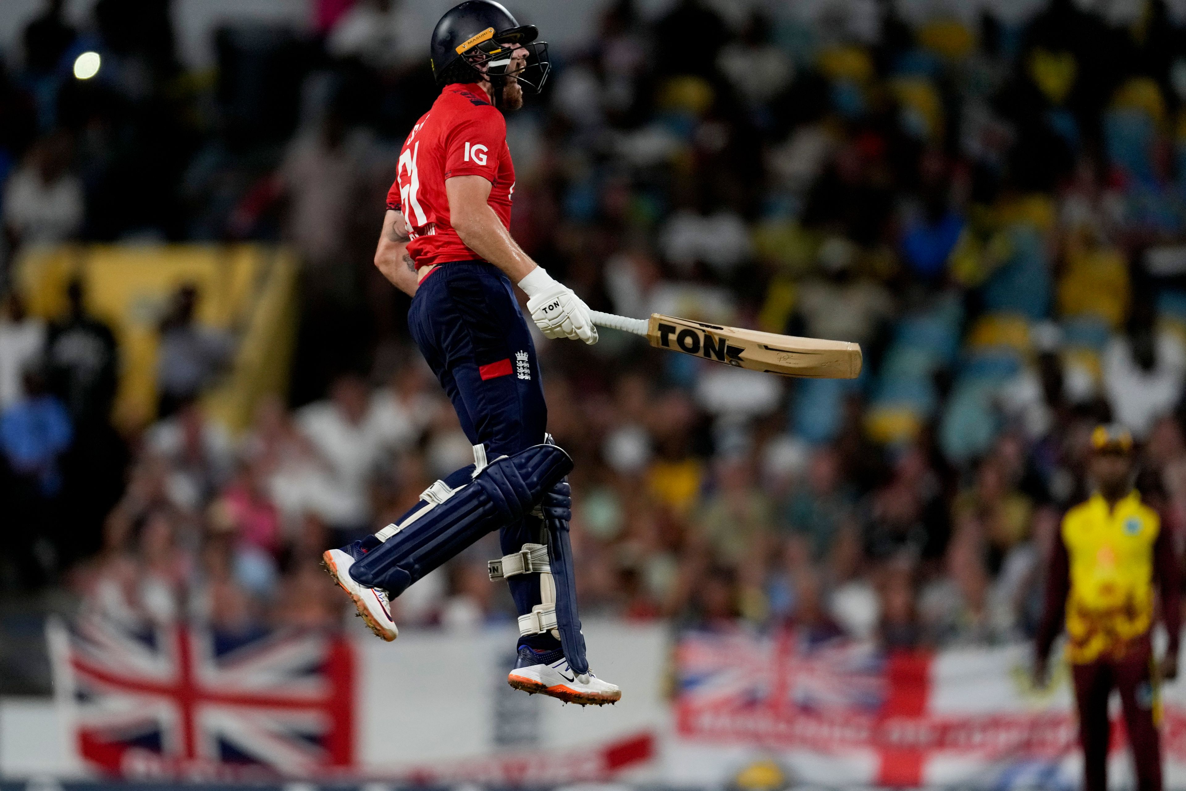 England's Phil Salt celebrates scoring a century against West Indies during the first T20 cricket match at Kensington Oval in Bridgetown, Barbados, Saturday, Nov. 9, 2024. (AP Photo/Ricardo Mazalan)