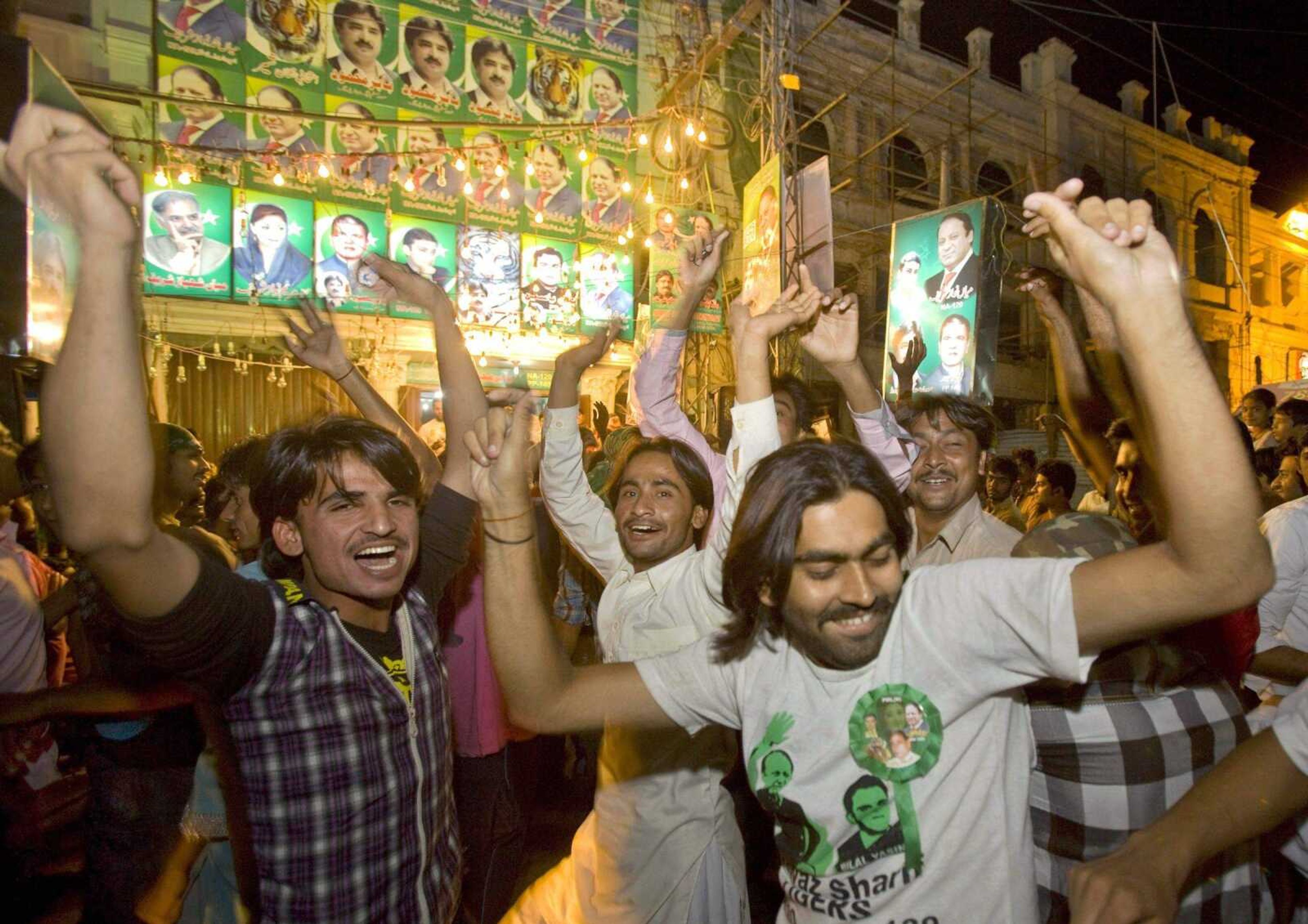 Supporters of Pakistan Muslim League-N party celebrate the primary unofficial results of the country's parliamentary elections at a party office in Lahore, Pakistan, Saturday, May 11, 2013. The Pakistan Muslim League-N party, led by two-time Prime Minister Nawaz Sharif, has long been considered the front-runner in the race. The party appeared to be moving toward a significant victory Saturday based on partial vote counts announced by Pakistan state TV. (AP Photo/Anjum Naveed)