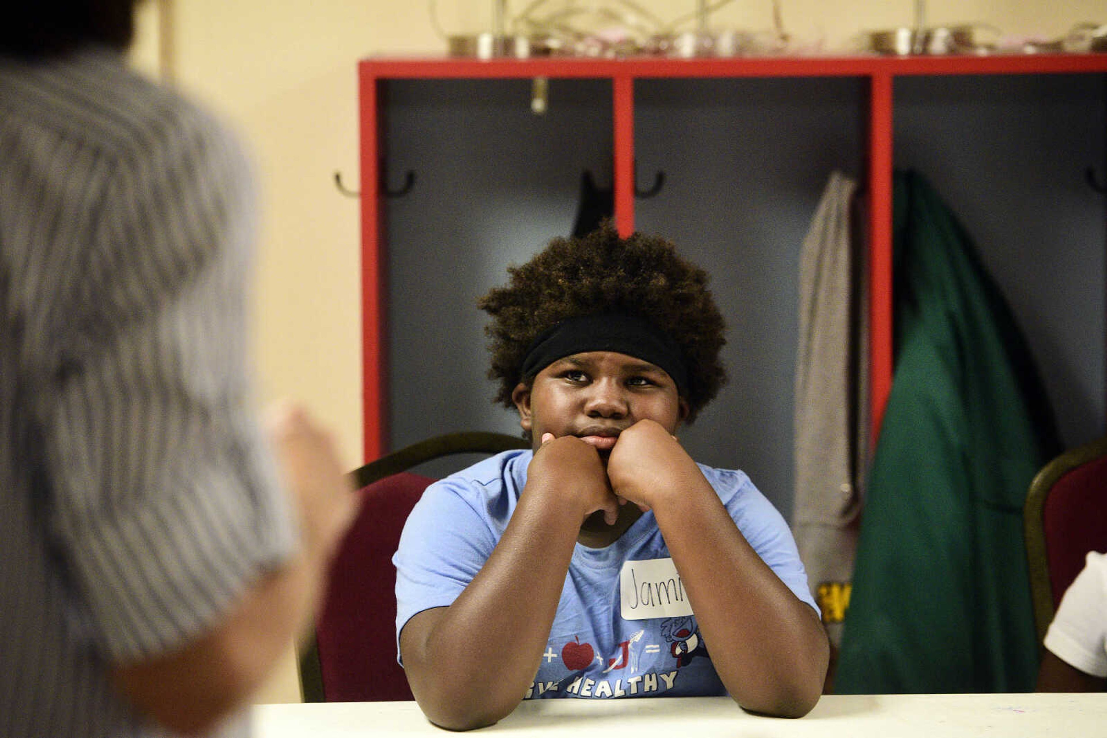 Jamia Maney listens to Debbie Bowers speak on Monday, Aug. 14, 2017, during the Salvation Army's after school program at The Bridge Outreach Center in Cape Girardeau.