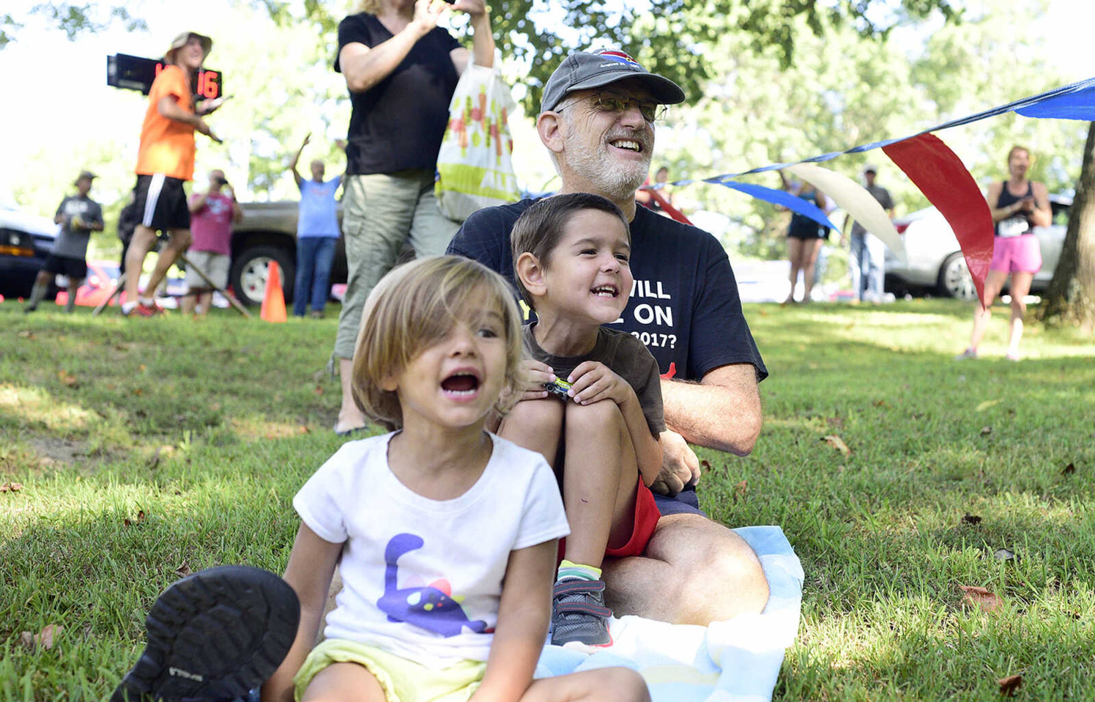 Olivia and Lucas Gerlach cheer on their aunt while sitting with their grandfather Mark Langenfeld during the first ever St. Jude Heroes Yak 'n Run on Saturday, Aug. 26, 2017, at Trail of Tears State Park. All proceeds from the event support St. Jude Children's Research Hospital