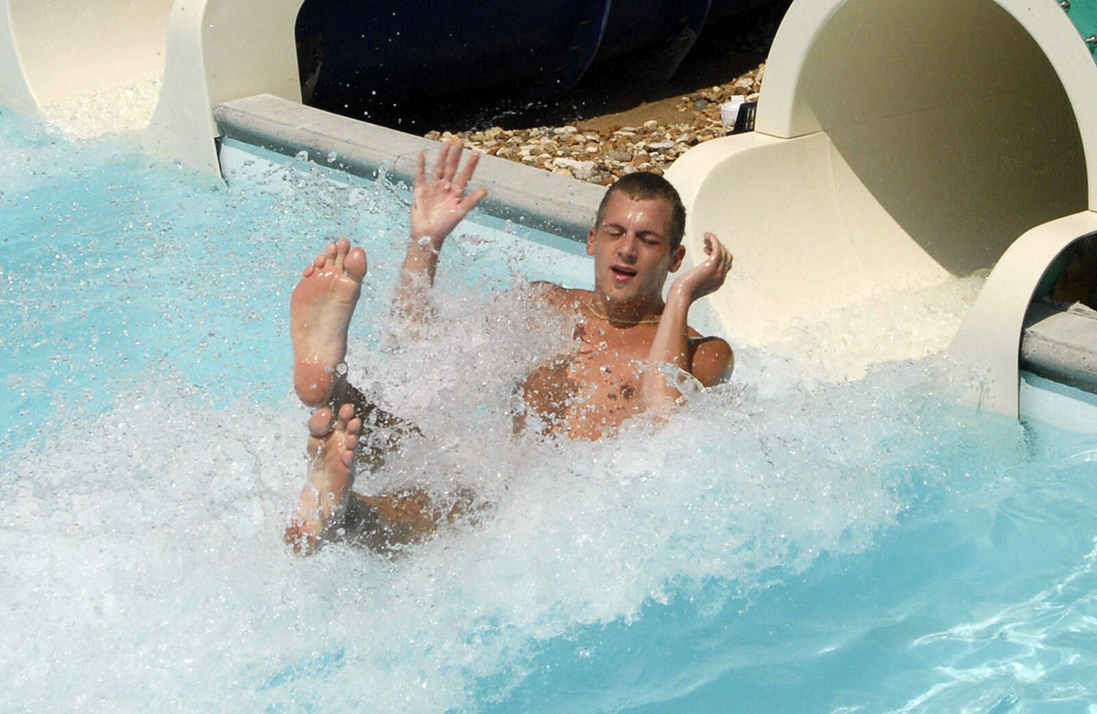 LAURA SIMON~lsimon@semissourian.com
Tobias Apel shoots out from the water slide Saturday, May 28, 2011 during opening day of Cape Splash Family Aquatic Center in Cape Girardeau.