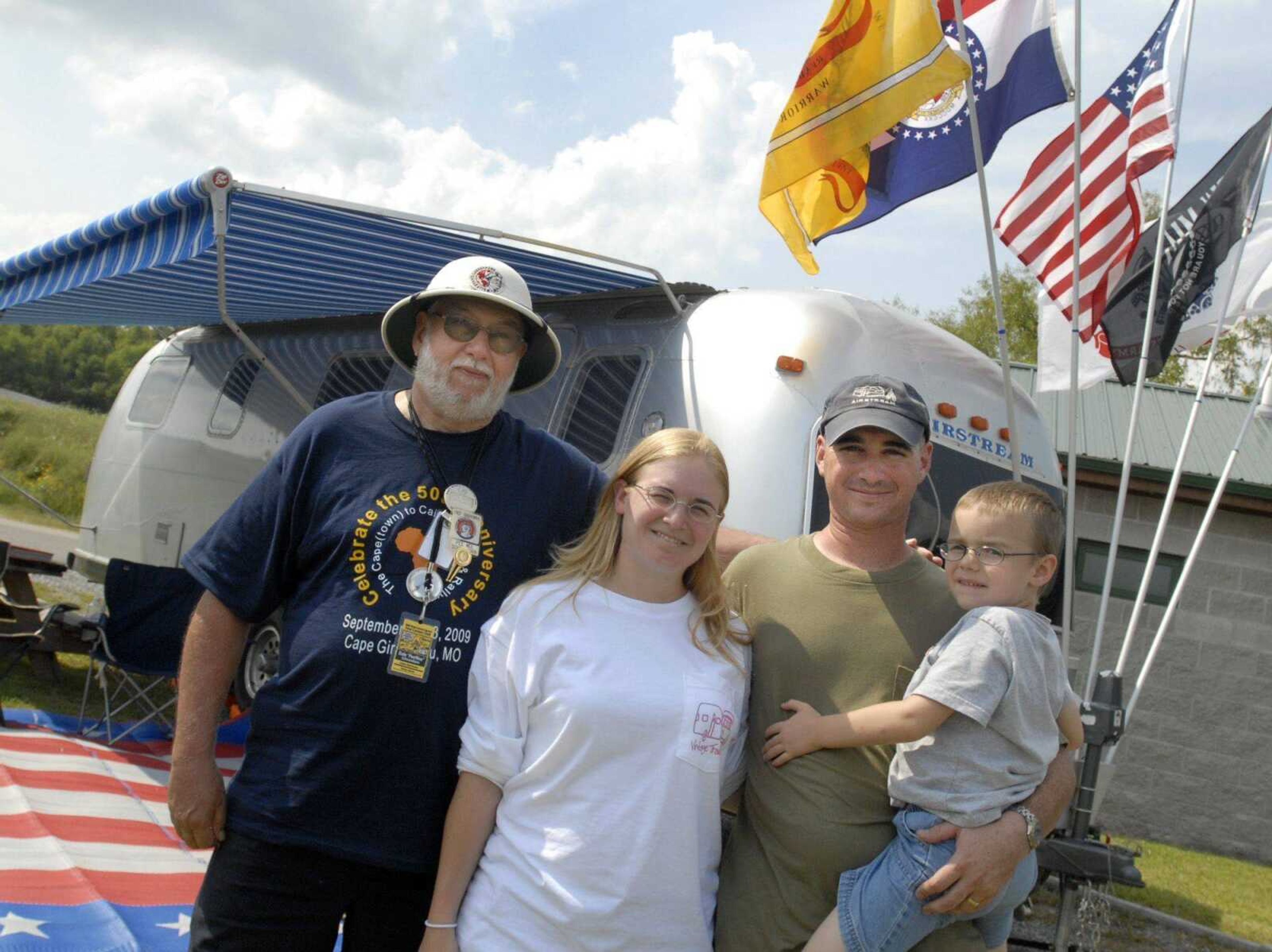 The lead scout for the 1959 Airstream caravan across Africa, Dale "Pee Wee" Schwamborn, left, of Prescott, Ariz., poses Saturday with his host family, Steve and Amy Burrows and their son, Collin, at Cape Girardeau RV Park. (Fred Lynch)