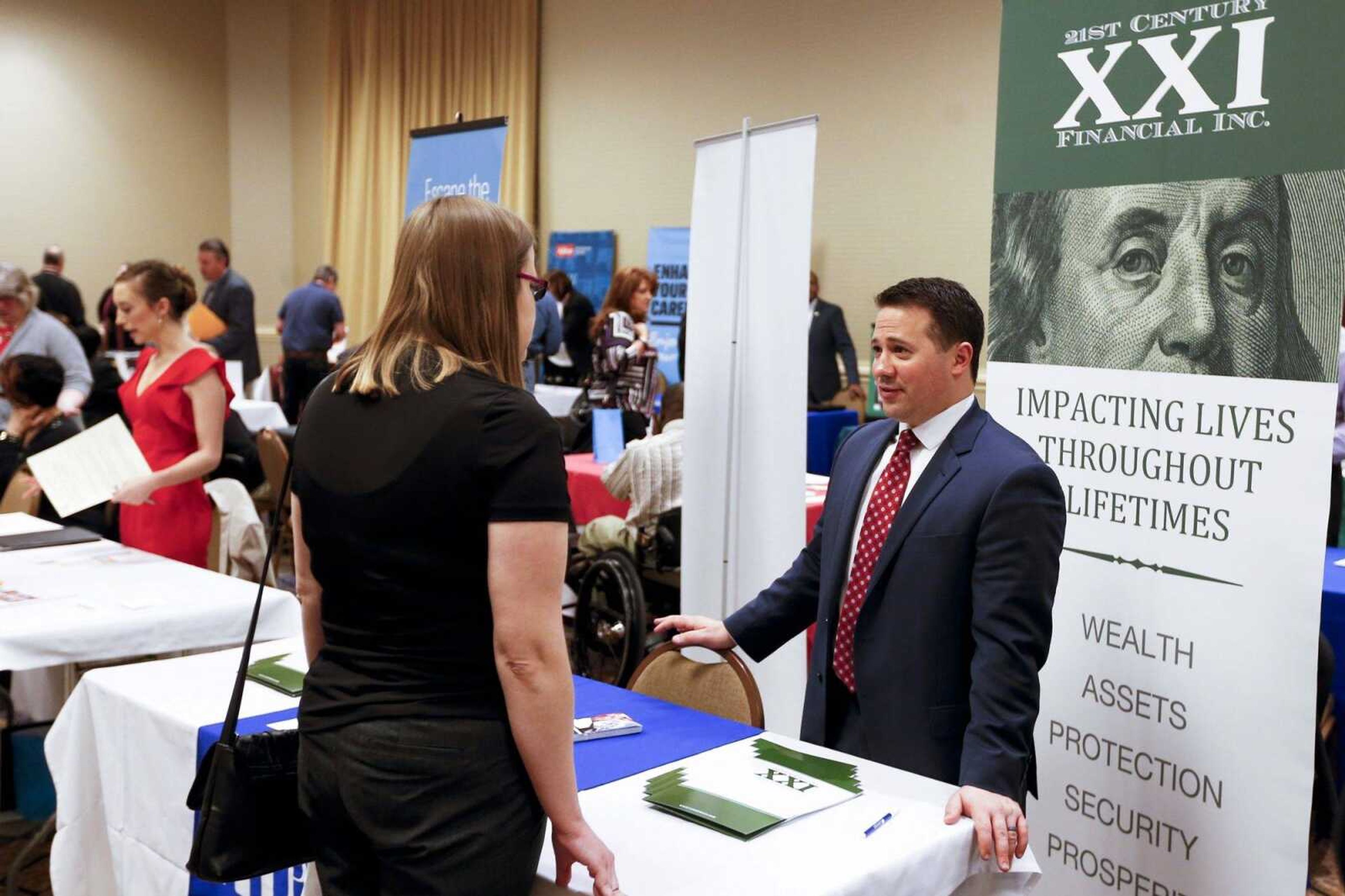 Recruiters speak to attendees at a job fair March 30 in Pittsburgh.