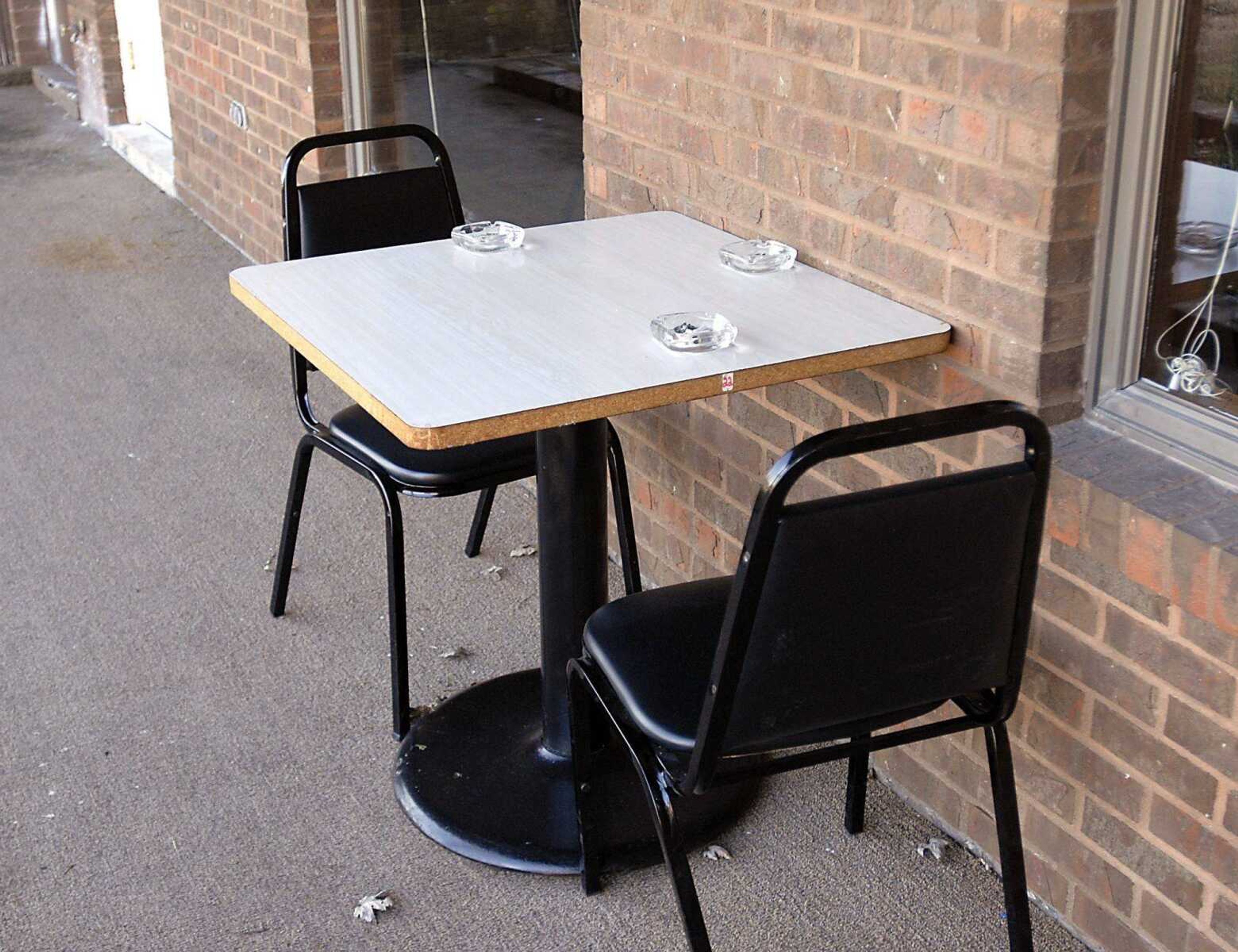 Smoking is permitted at this table outside the rear of The Rose Garden restaurant in East Cape Girardeau, Ill.