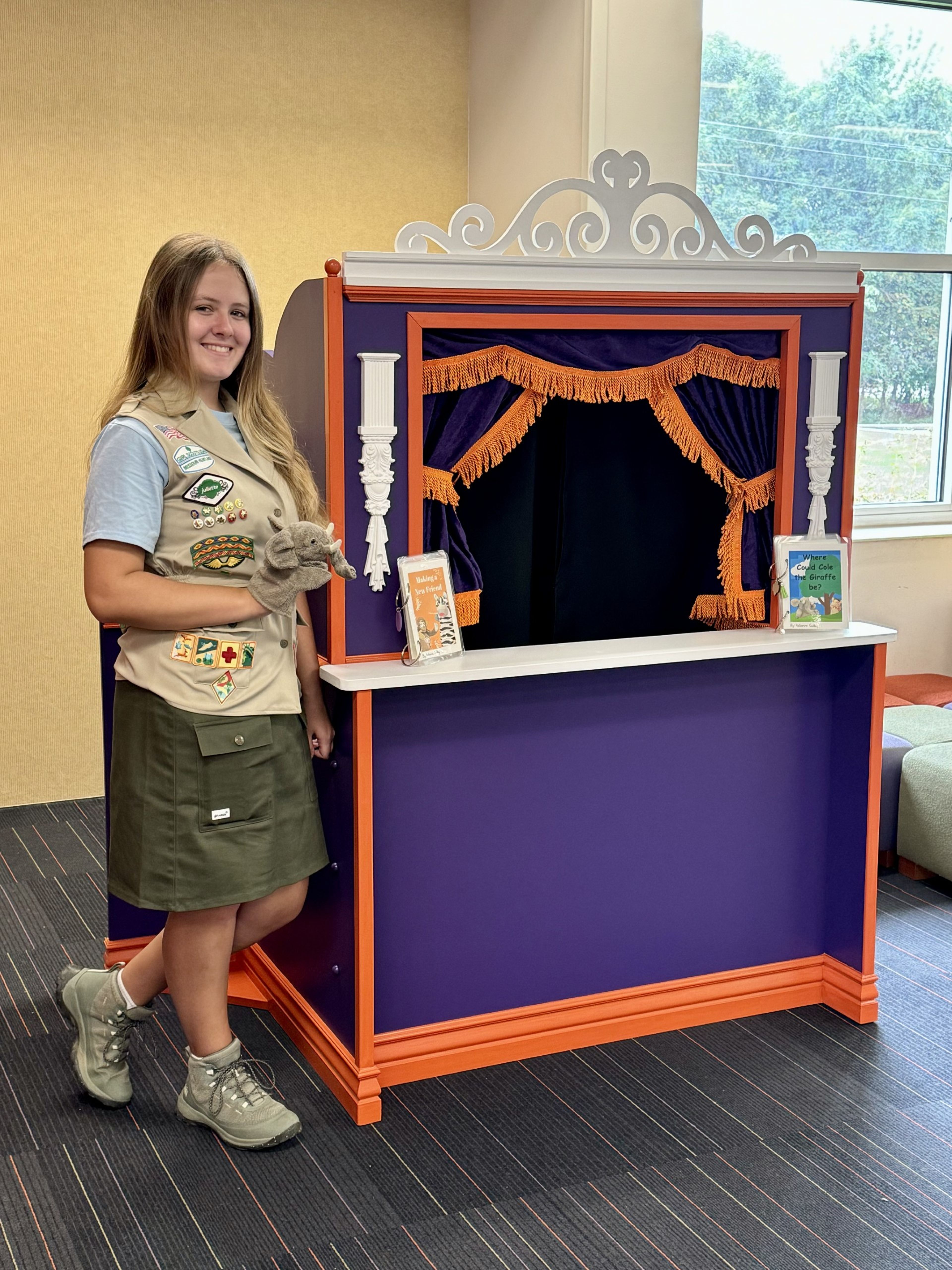 Cape Girardeau Central High School student Katherine Godbey next to her puppet theater at the Cape Girardeau Public Library.