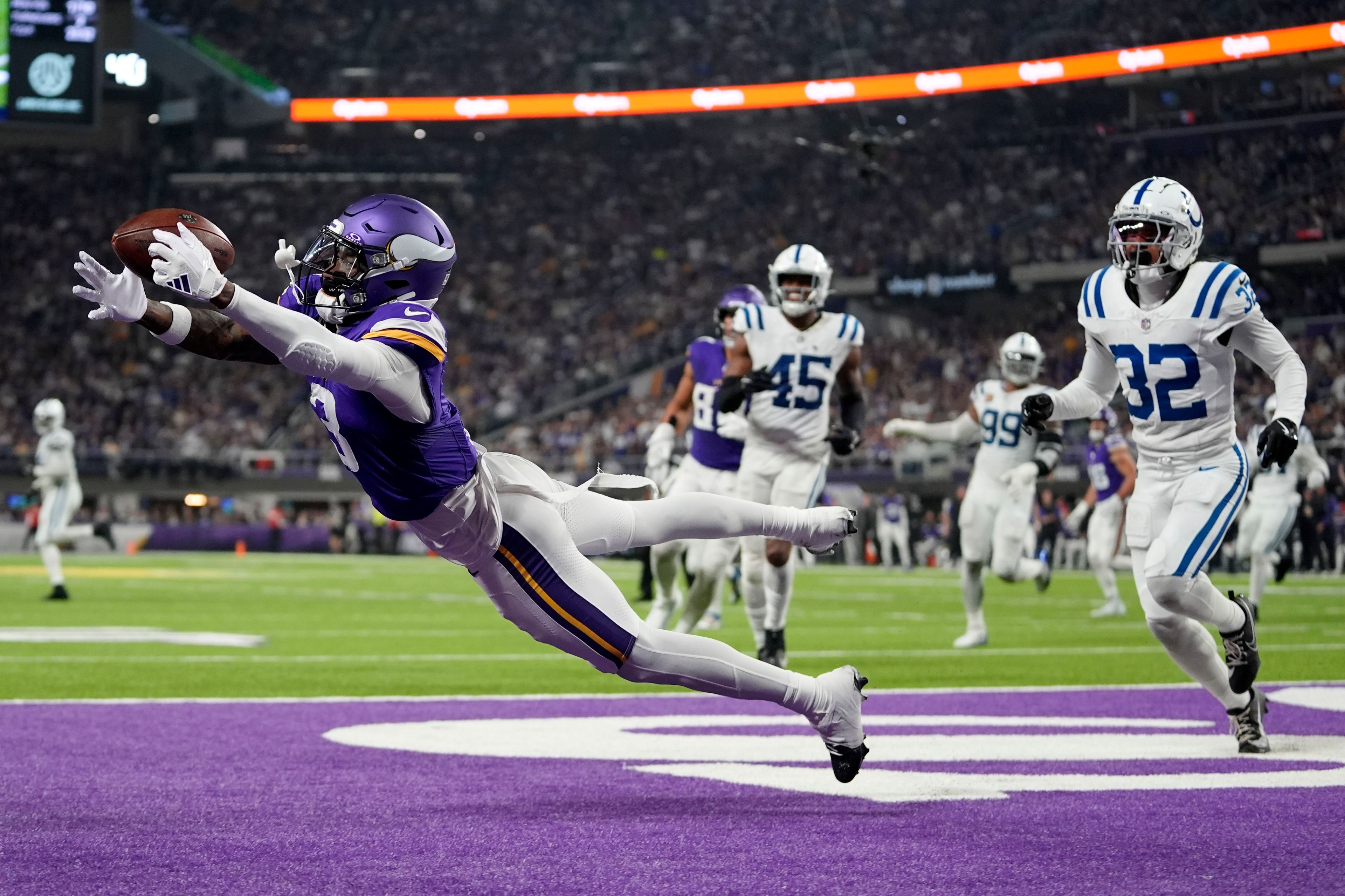 Minnesota Vikings wide receiver Jordan Addison (3) catches a 4-yard touchdown pass ahead of Indianapolis Colts safety Julian Blackmon (32) during the second half of an NFL football game, Sunday, Nov. 3, 2024, in Minneapolis. (AP Photo/Abbie Parr)