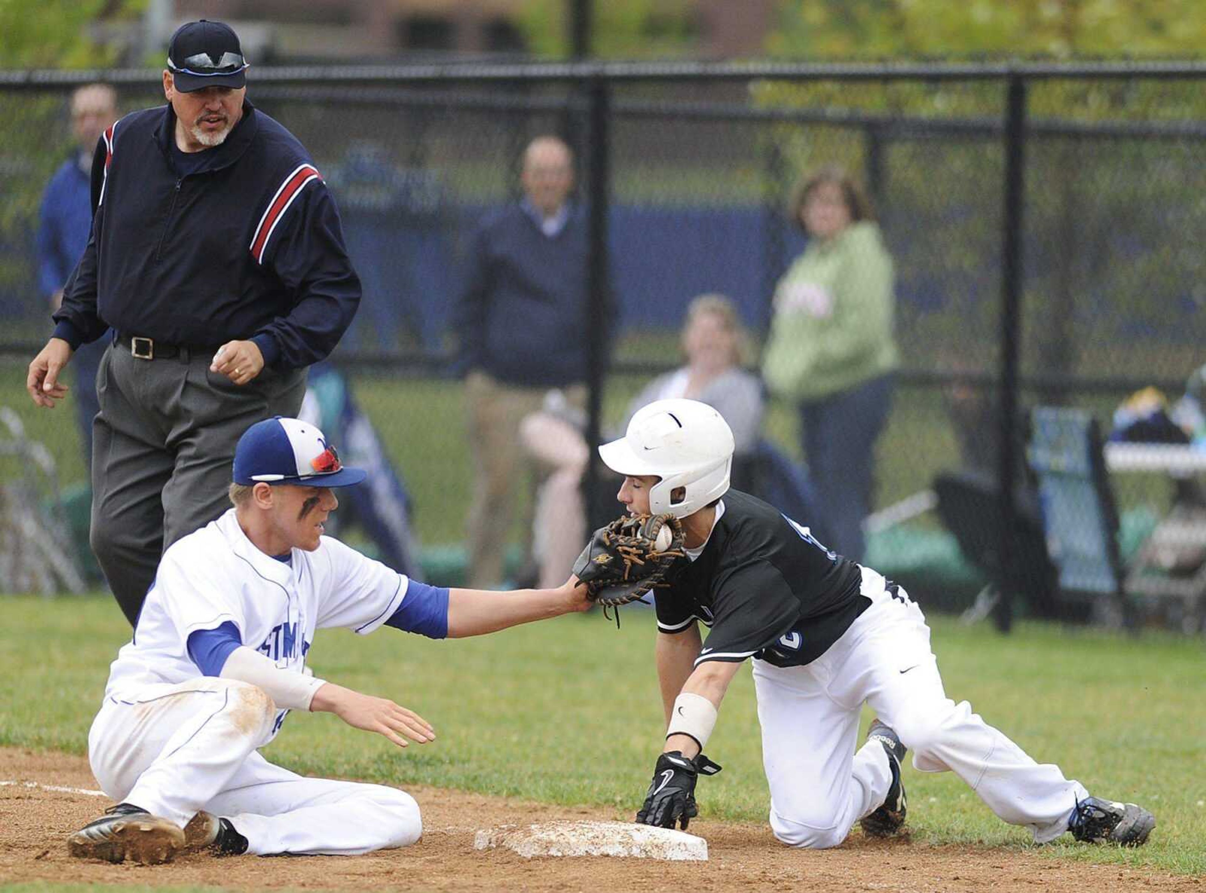 Notre Dame's Griffin Siebert gets tagged out at first by Westminster first baseman Andrew Colgrove in a pick off play in the second inning of the Bulldogs' 7-5 loss to the Wildcats in the Class 4 Quarterfinal Thursday, May 23, in Town and Country, Mo. (ADAM VOGLER)