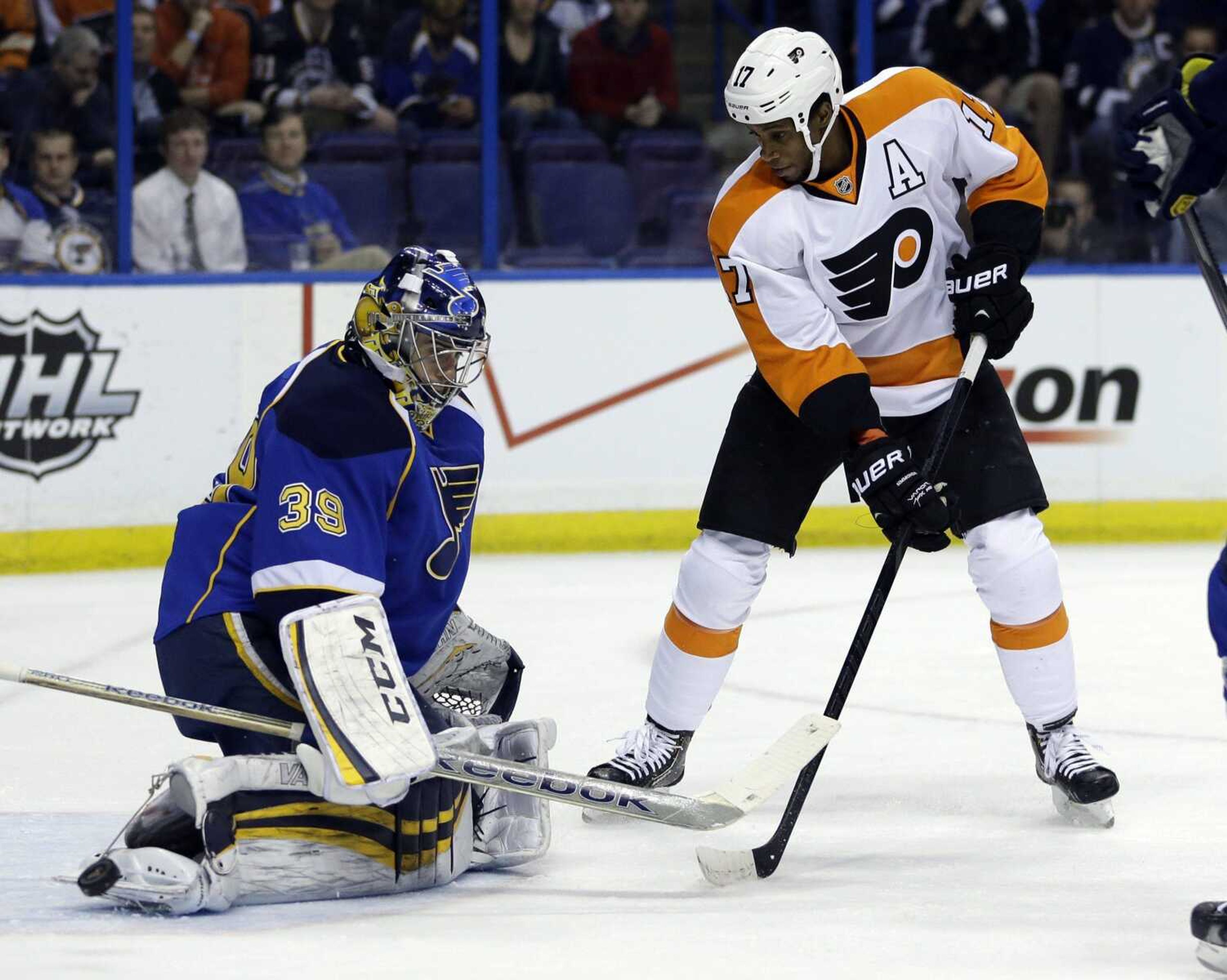 The Flyers&#8217; Wayne Simmonds, right, watches as St. Louis Blues goalie Ryan Miller deflects a puck during the first period Tuesday in St. Louis. The Blues won 1-0 in a shootout. (Jeff Roberson ~ Associated Press)