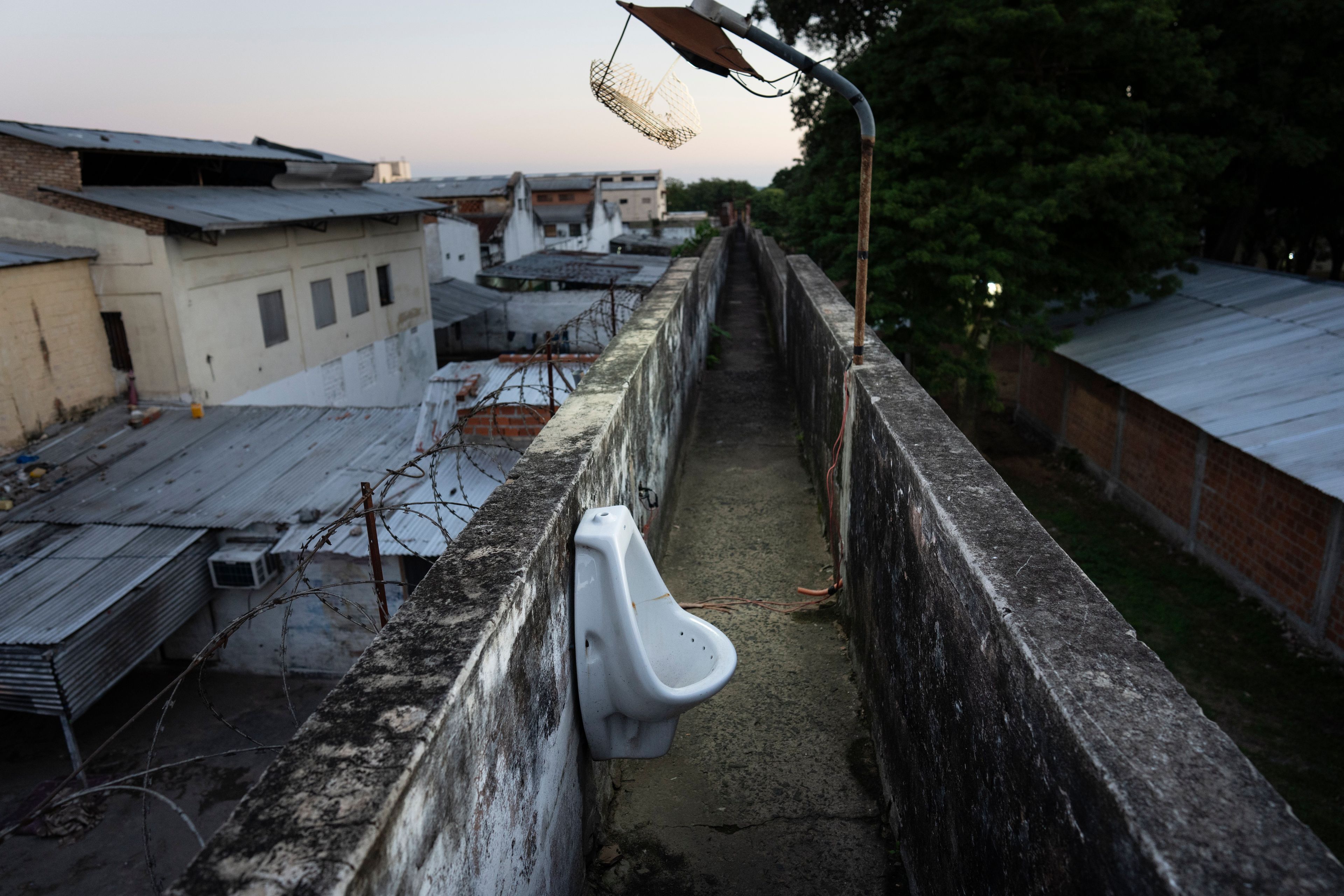 A urinal is located along an observation walkway for security guards at the Tacumbu prison in Asuncion, Paraguay, Sunday, July 8, 2024. (AP Photo/Rodrigo Abd)