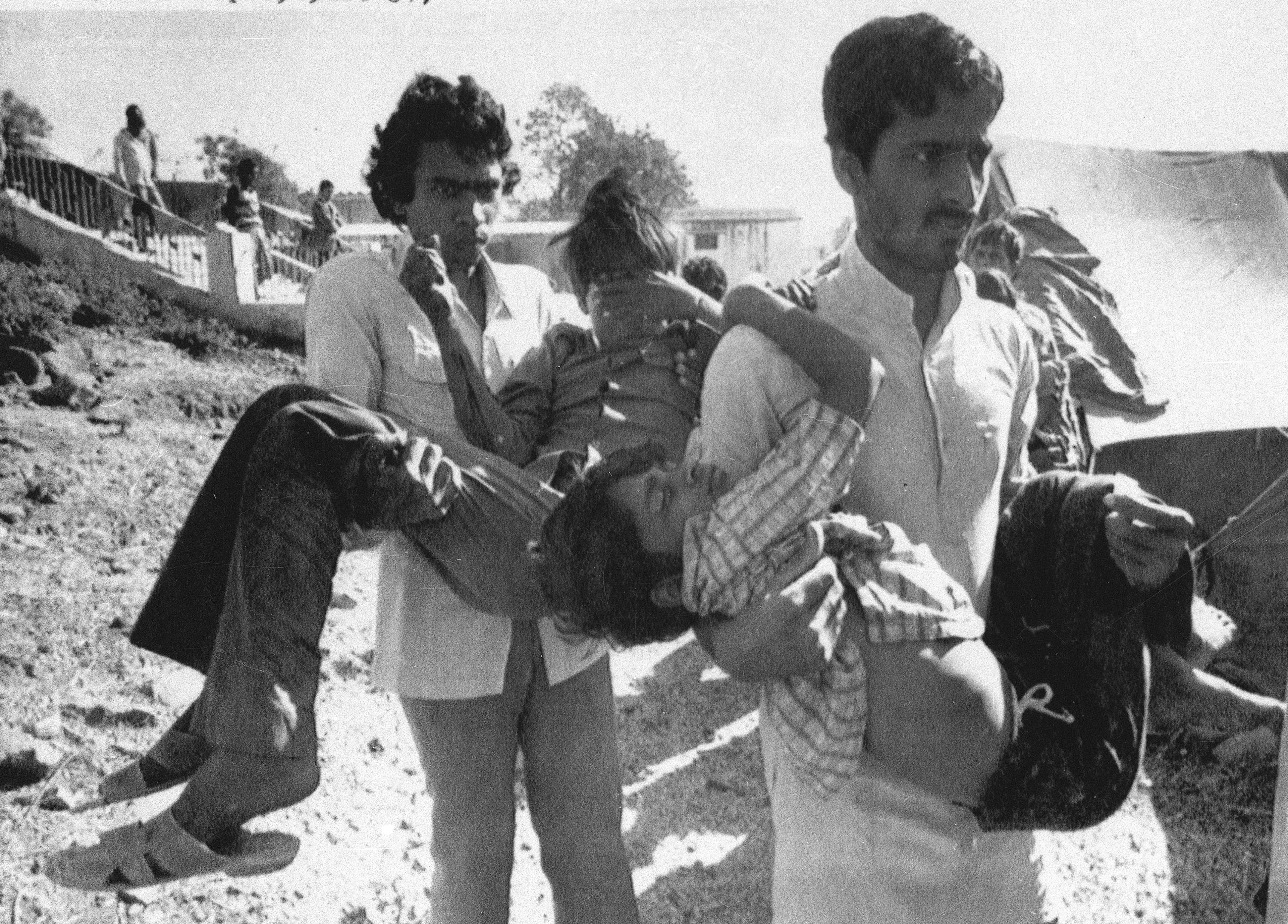 Two men carry children blinded by the Union Carbide chemical pesticide leak to a hospital in Bhopal, India, Dec. 5, 1984. Thousands were killed and seriously injured in the gas leak. 