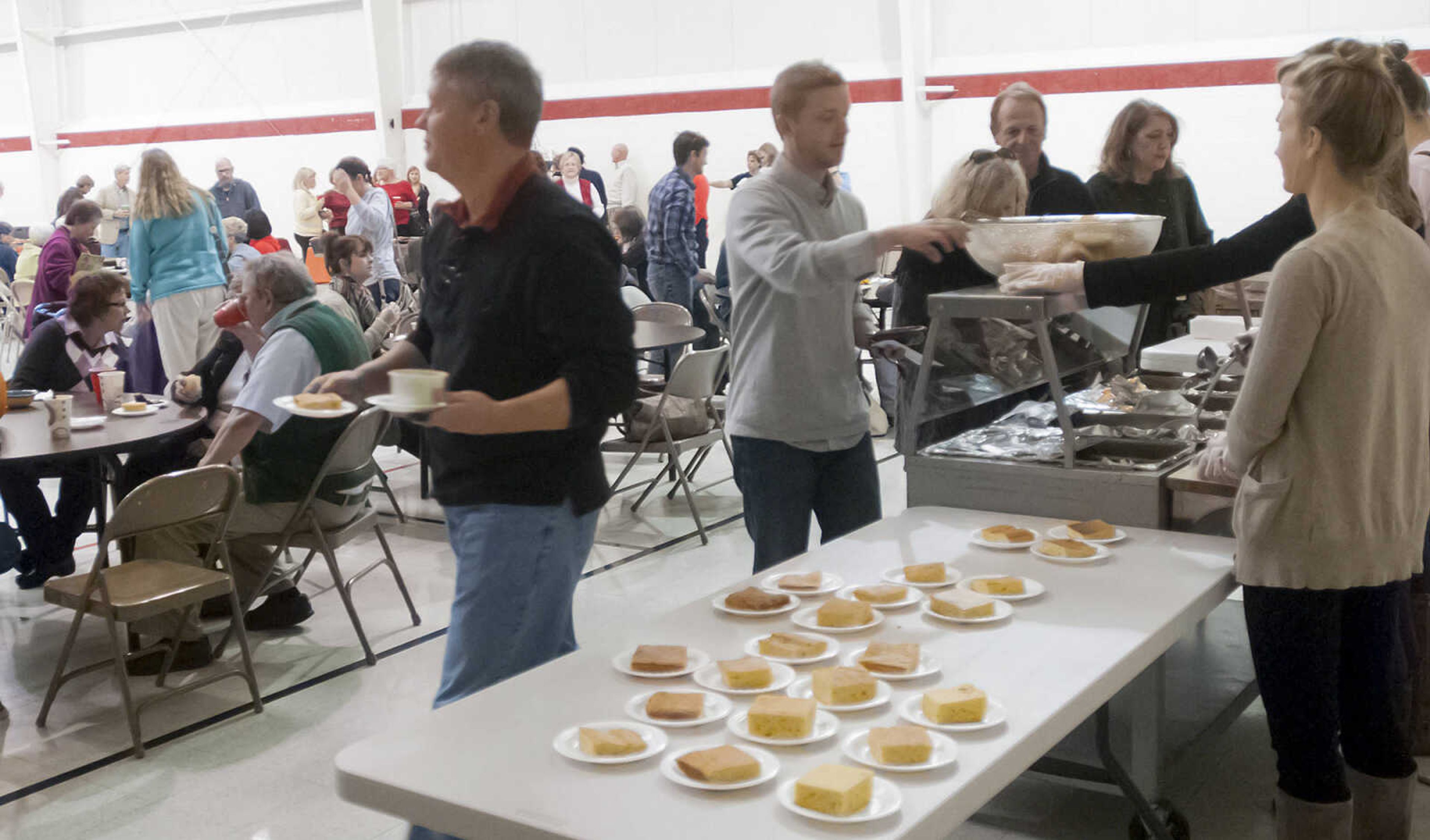 People make their way down the soup line at the 8th annual Empty Bowls banquet, Sunday, Nov. 3, at the Salvation Army, 701 Good Hope St, in Cape Girardeau. Attendees received a hand made bowl and a simple soup lunch, which included soup, bread, drink and desert, in exchange for $12. Proceeds from the event go towards the Salvation Army's meals with friends program.