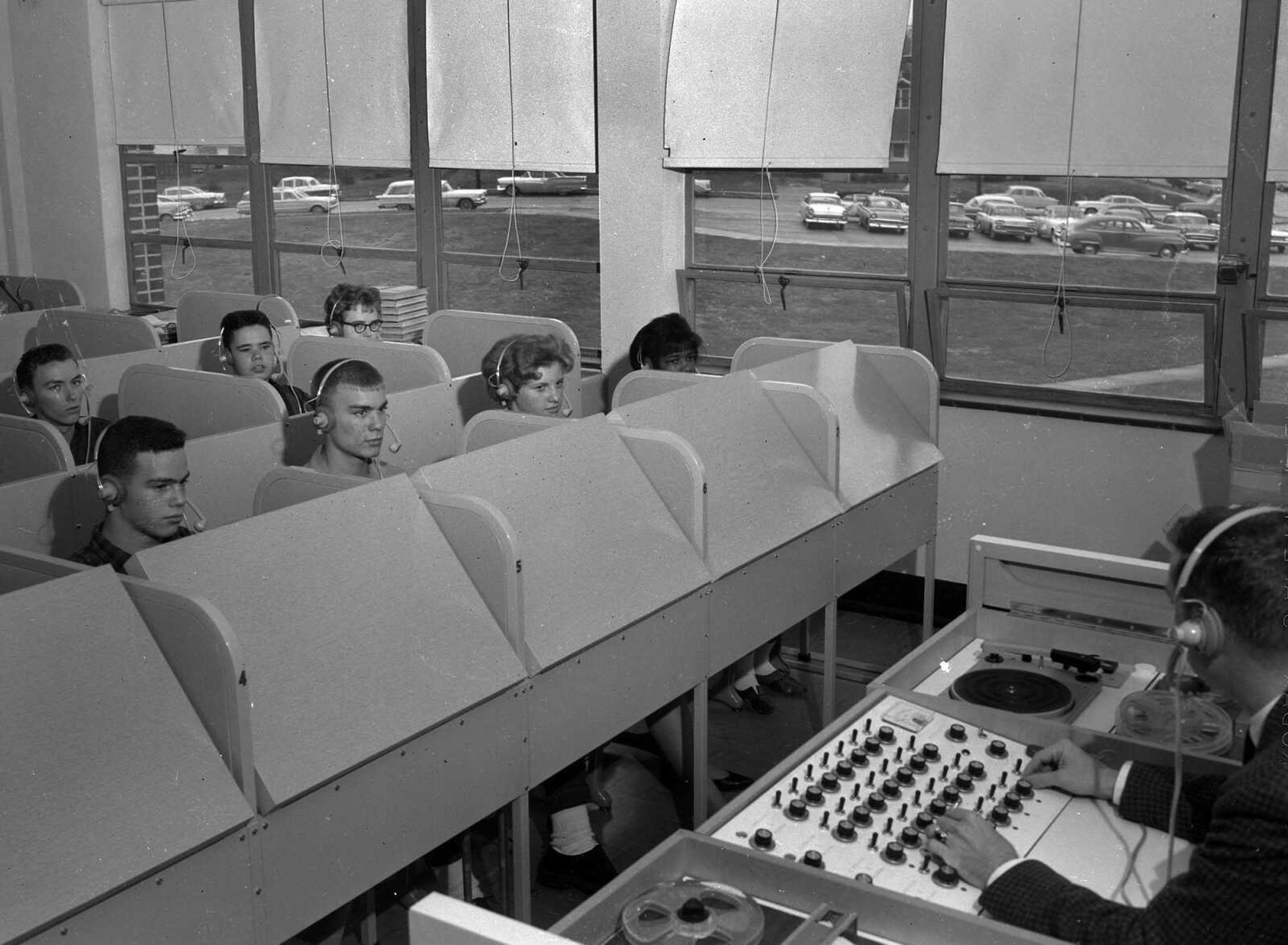 In 1962, this Central High Spanish instructor directed his class through a console unit which placed him and recording facilities in communication with the pupils in the booths. The teacher was Dan M. Moore, and the pupils from left, in front, were Larry Blitstein, Louis Loos, Charlene McNeil and Lawanda Haynes. At the back from left were Rich Merkle, Randy Morse and Helen Miner.