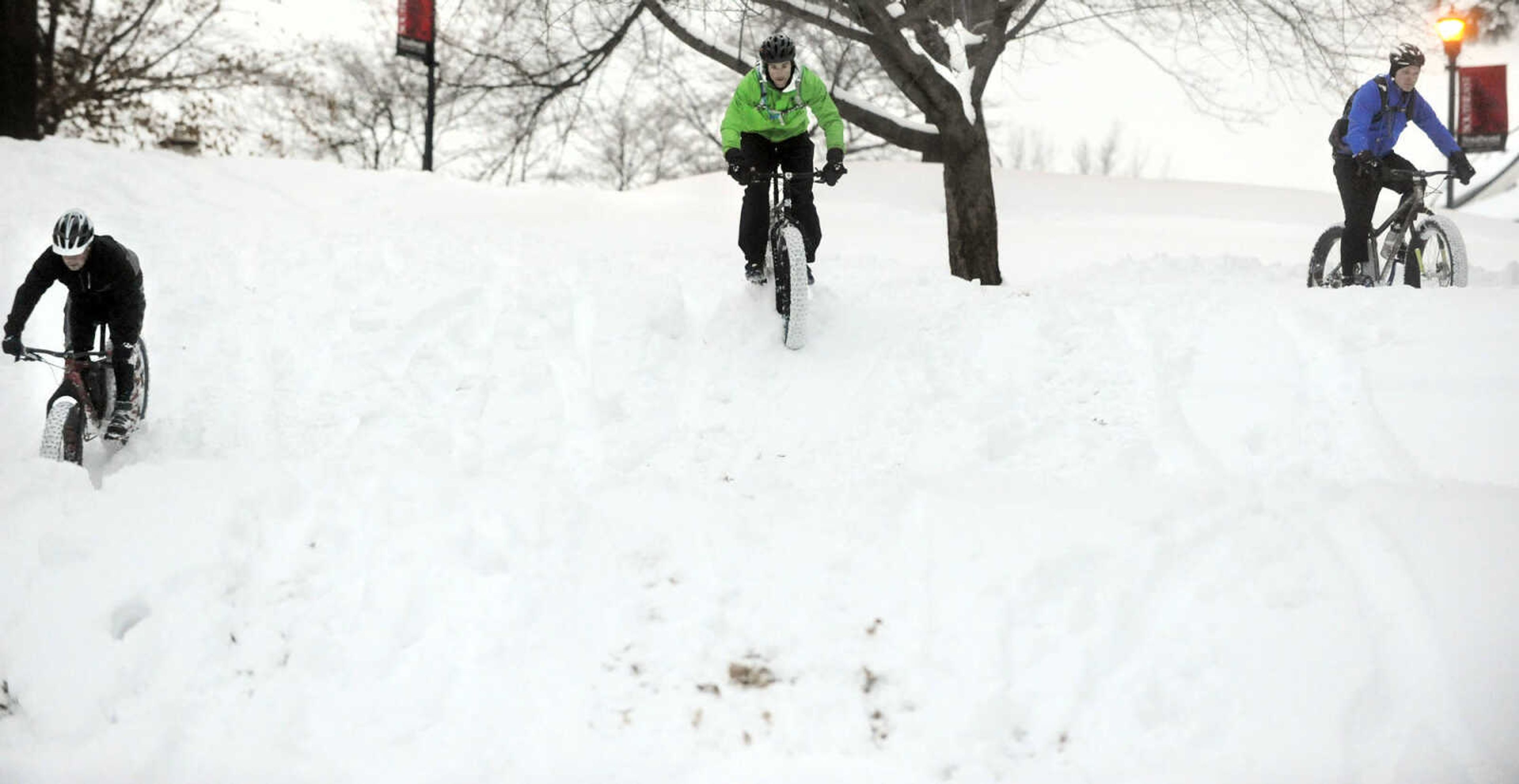 LAURA SIMON ~ lsimon@semissourian.com

Bob Berck, left, Tim Vollink, center, and John Dodd ride fat bikes through the snow on the terraces outside Academic Hall Tuesday evening, Feb. 17, 2015.