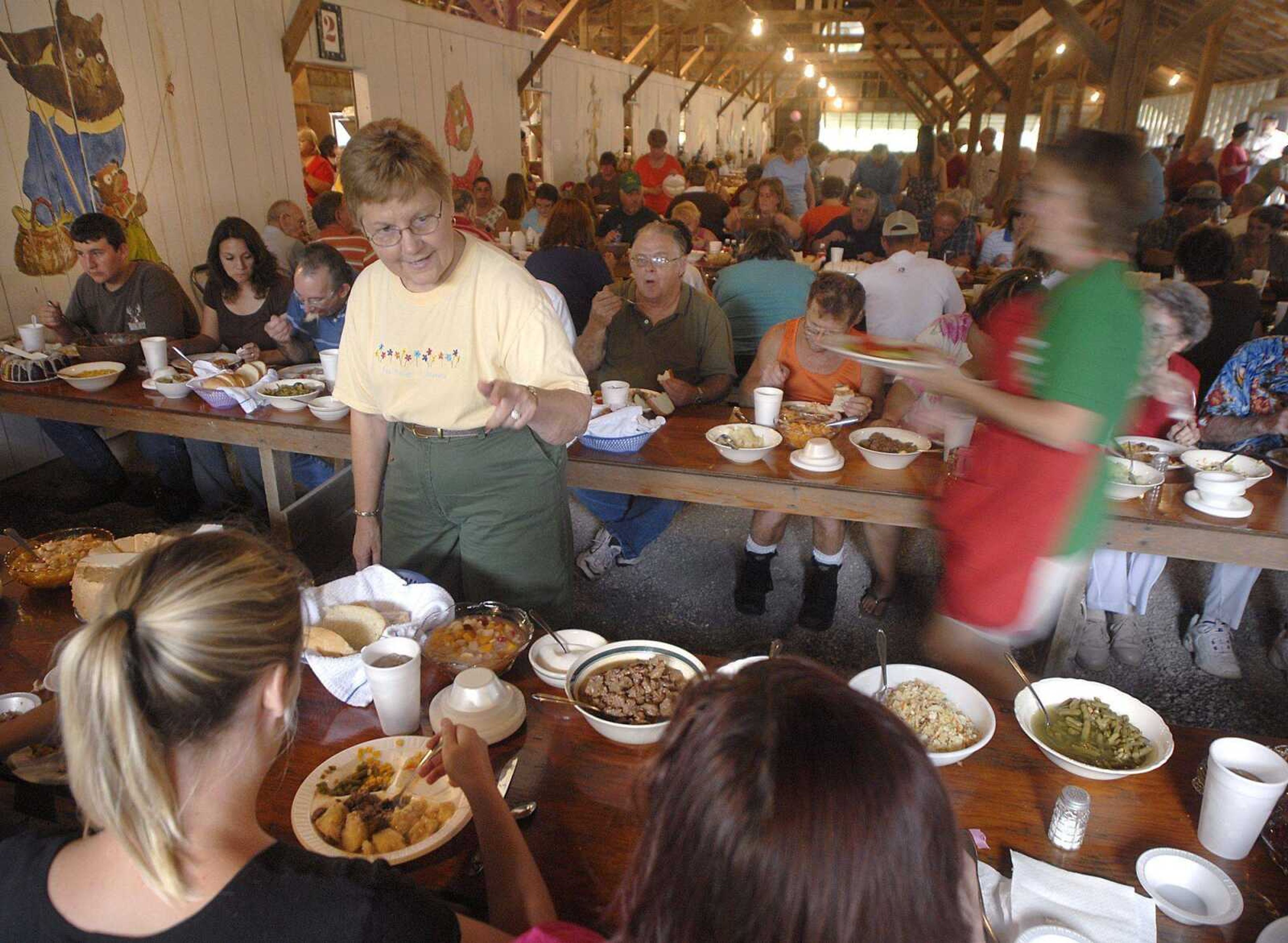 Geri Geringer chats with people Saturday at the Leopold Picnic in Leopold, Mo. Geringer has come back to the annual picnic over the years, working with family members at the same table since she was a child. (Fred Lynch)