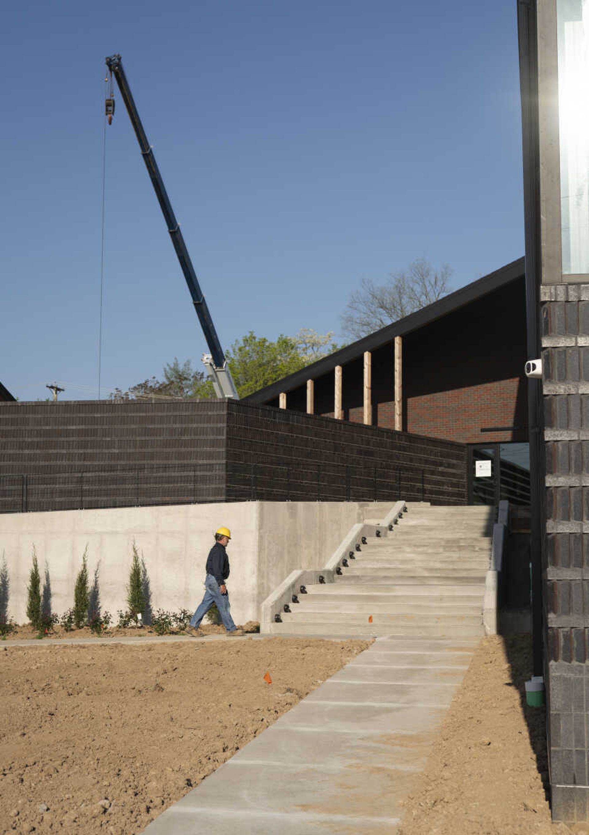 Crews work on landscaping and put the finishing touches on the new Catholic Charities of Southeast Missouri LifeHouse. (Photo by Aaron Eisenhauer)