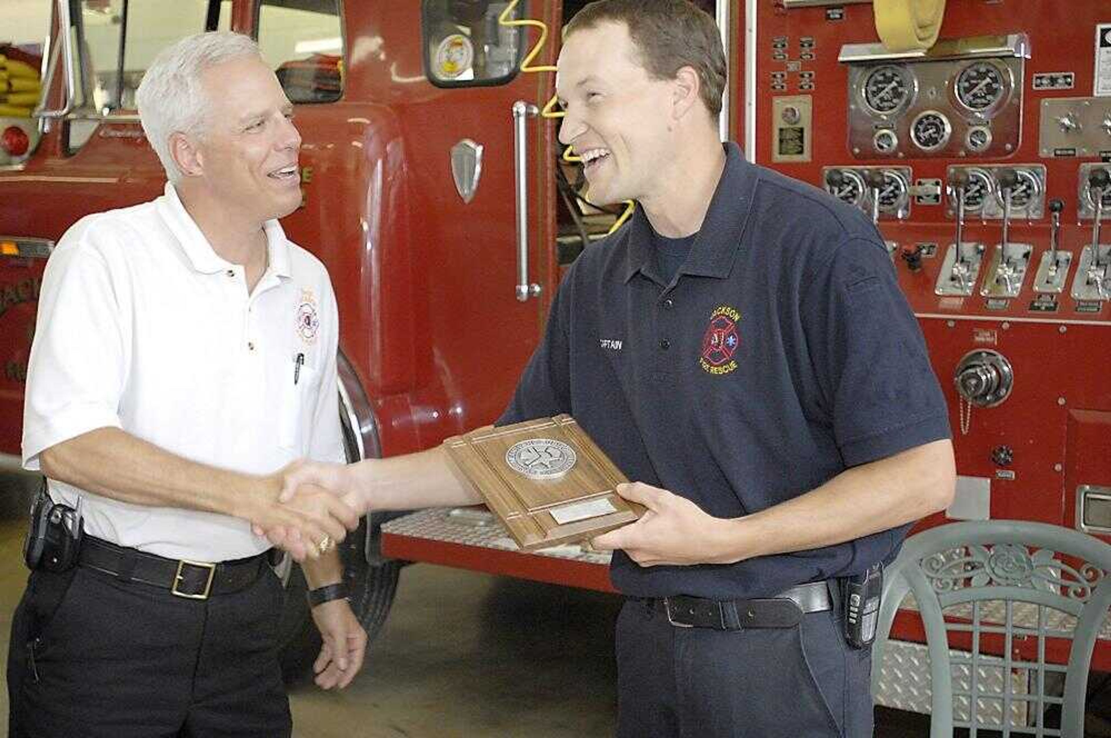 Jackson fire chief Brad Golden, left, congratulated Captain Jason Mouser upon receiving Heartland Public Safety Supply's Firefighter of the Year award Thursday at the Jackson Fire Department. (Kit Doyle)