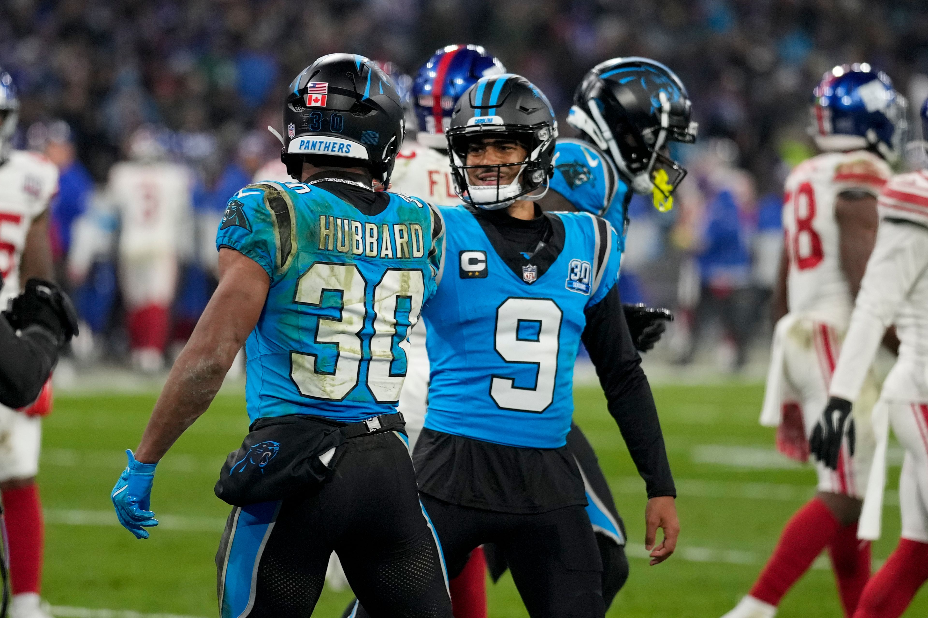 Carolina Panthers running back Chuba Hubbard celebrates his touchdown with quarterback Bryce Young during the second half of an NFL football game against the New York Giants, Sunday, Nov. 10, 2024, in Munich, Germany. (AP Photo/Matthias Schrader)