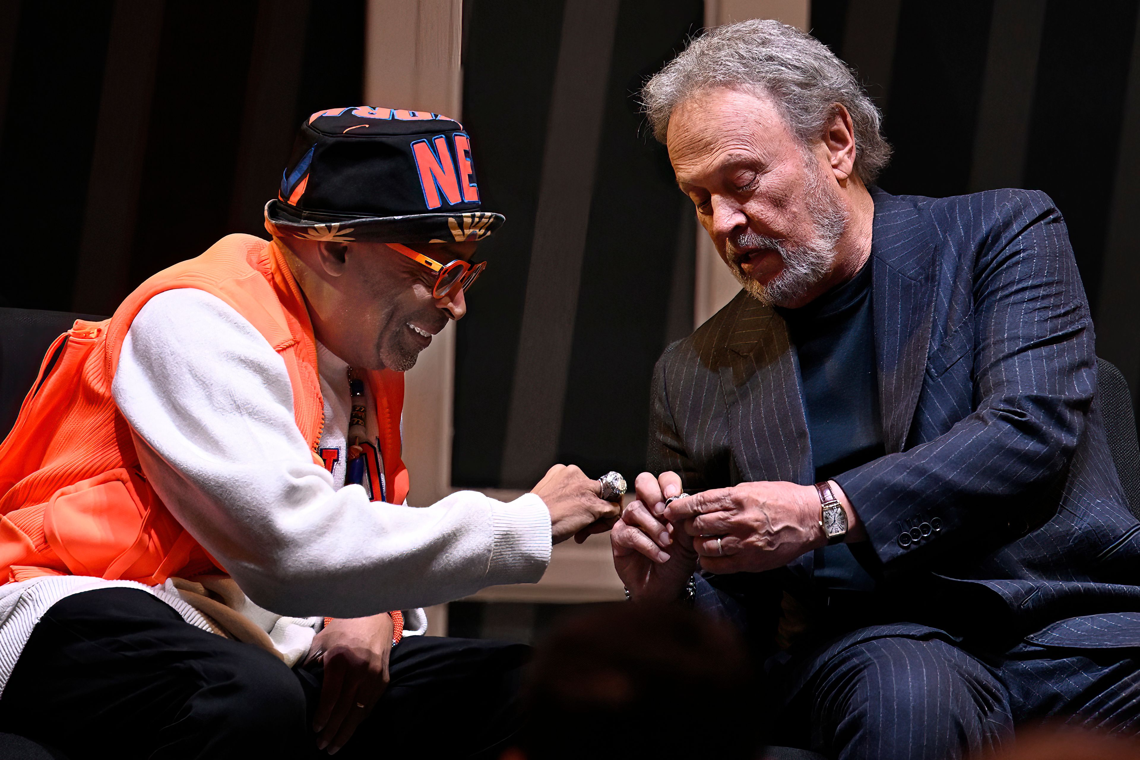 Film director Spike Lee, left, and comedian Billy Crystal, right, compare rings as they are honored at a superfan ceremony at the Basketball Hall of Fame, Sunday, Oct. 13, 2024, in Springfield, Mass. Lee, Crystal, actor Jack Nicholson and businessman Alan Horwitz are being added to the Naismith Memorial Basketball Hall of Fame's James F. Goldstein SuperFan Gallery. (AP Photo/Jessica Hill)