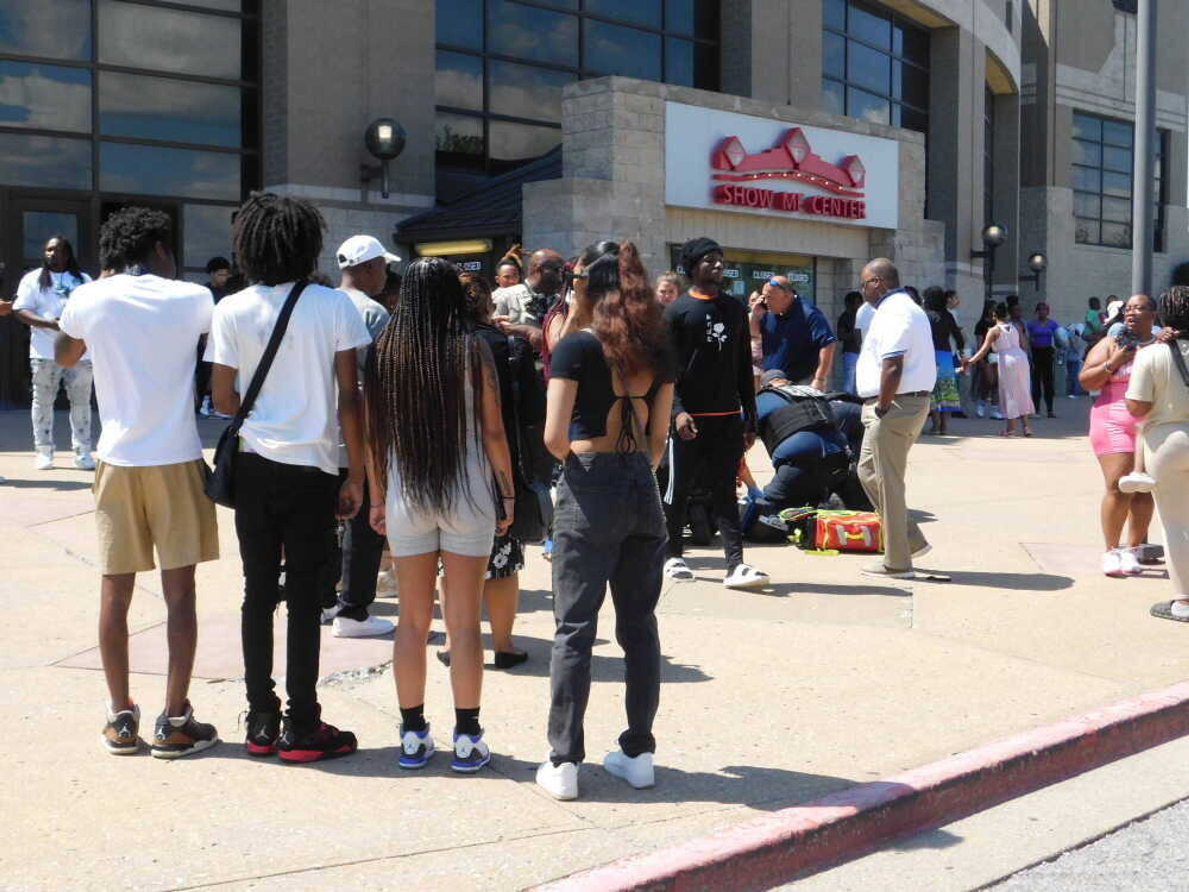 Medical personnel attend to a gunshot victim outside the Show Me Center on the campus of Southeast Missouri State University on Sunday, May 19. Two people sustained non-life-threatening injuries after one person fired one shot following an altercation inside the venue during Cape Girardeau Central High School's graduation ceremony.