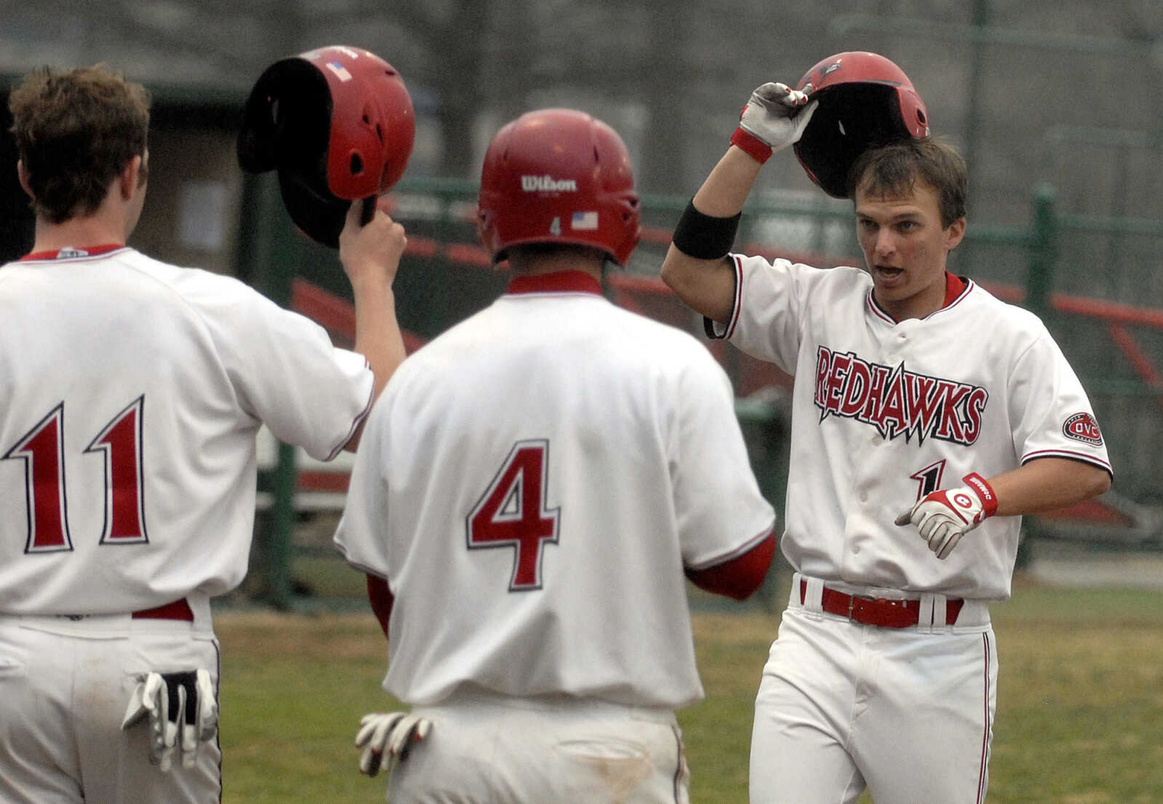 LAURA SIMON~lsimon@semissourian.com
Southeast players Jesse Tierney(11) and Kenton Parmley(4) congratulate teammate Michael Adamson on his three run homer in the fourth inning against Ball State Sunday, February 27, 2011 at Capaha Field. Southeast defeated Ball State 22-8.