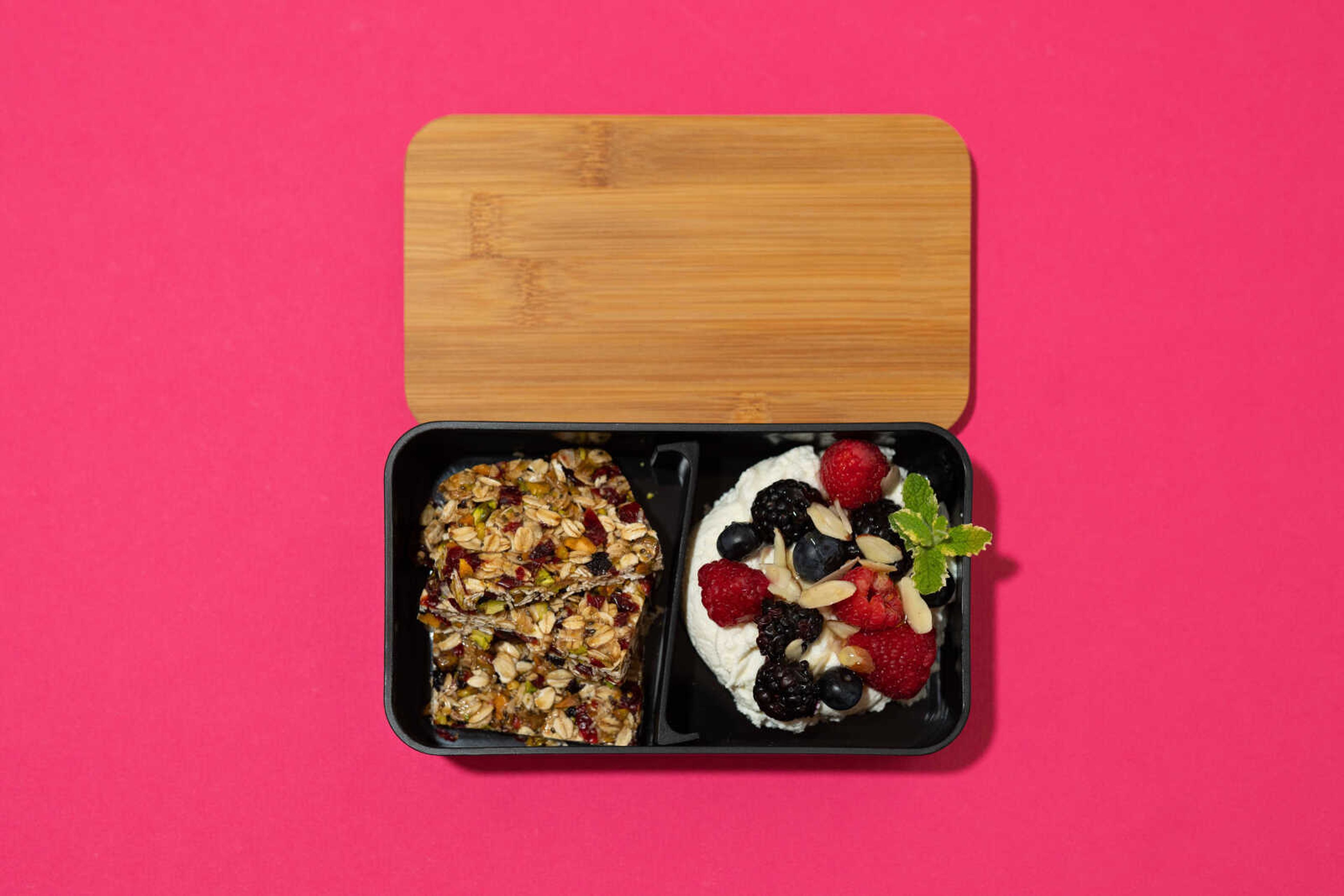 Cranberry pistachio bars with ricotta cheese, mixed berries and honey prepared by Ellen Gipson, MA, RDN, LD, are arranged in a bento box. The bento box originated in Japan.