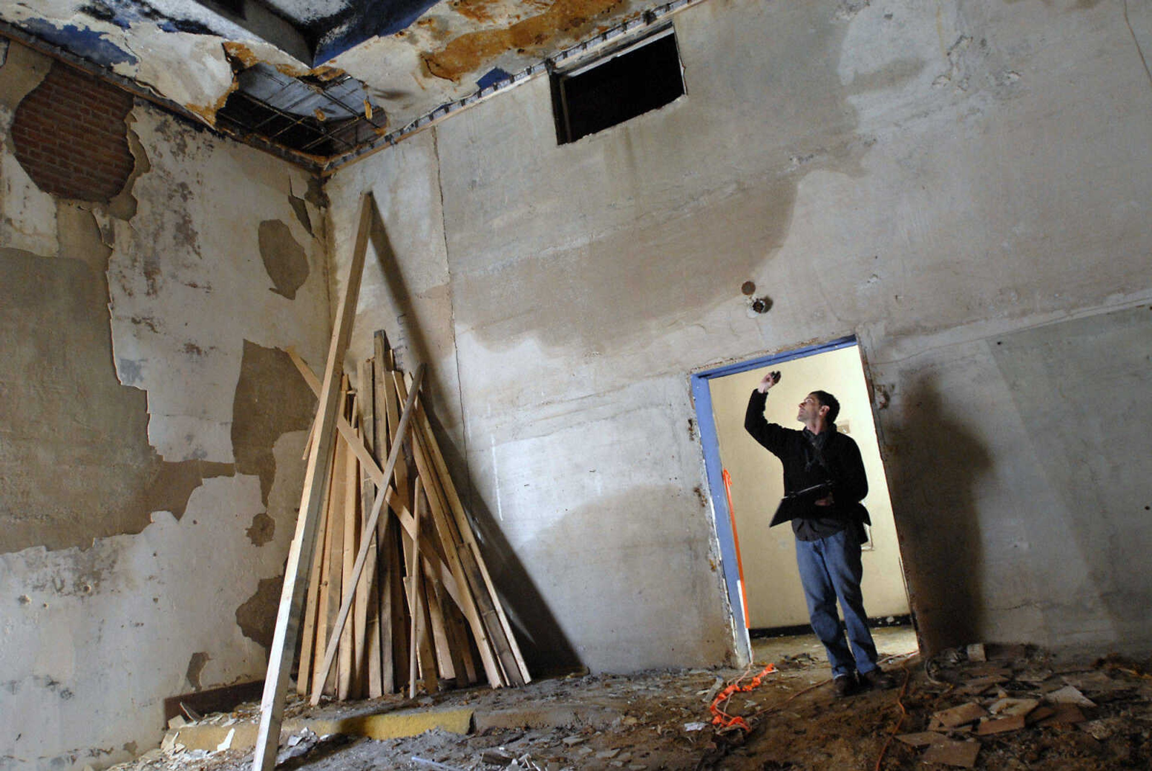 KRISTIN EBERTS ~ keberts@semissourian.com

David Leavey, of Kiku Obata & Company, works to take measurements of the Esquire Theater building on Friday, Jan. 6, 2012, in Cape Girardeau. Renovation work on the Esquire Theater continues as workers from Kiku Obata & Company and Penzel Construction complete field verification work and take measurements necessary for the design plans.