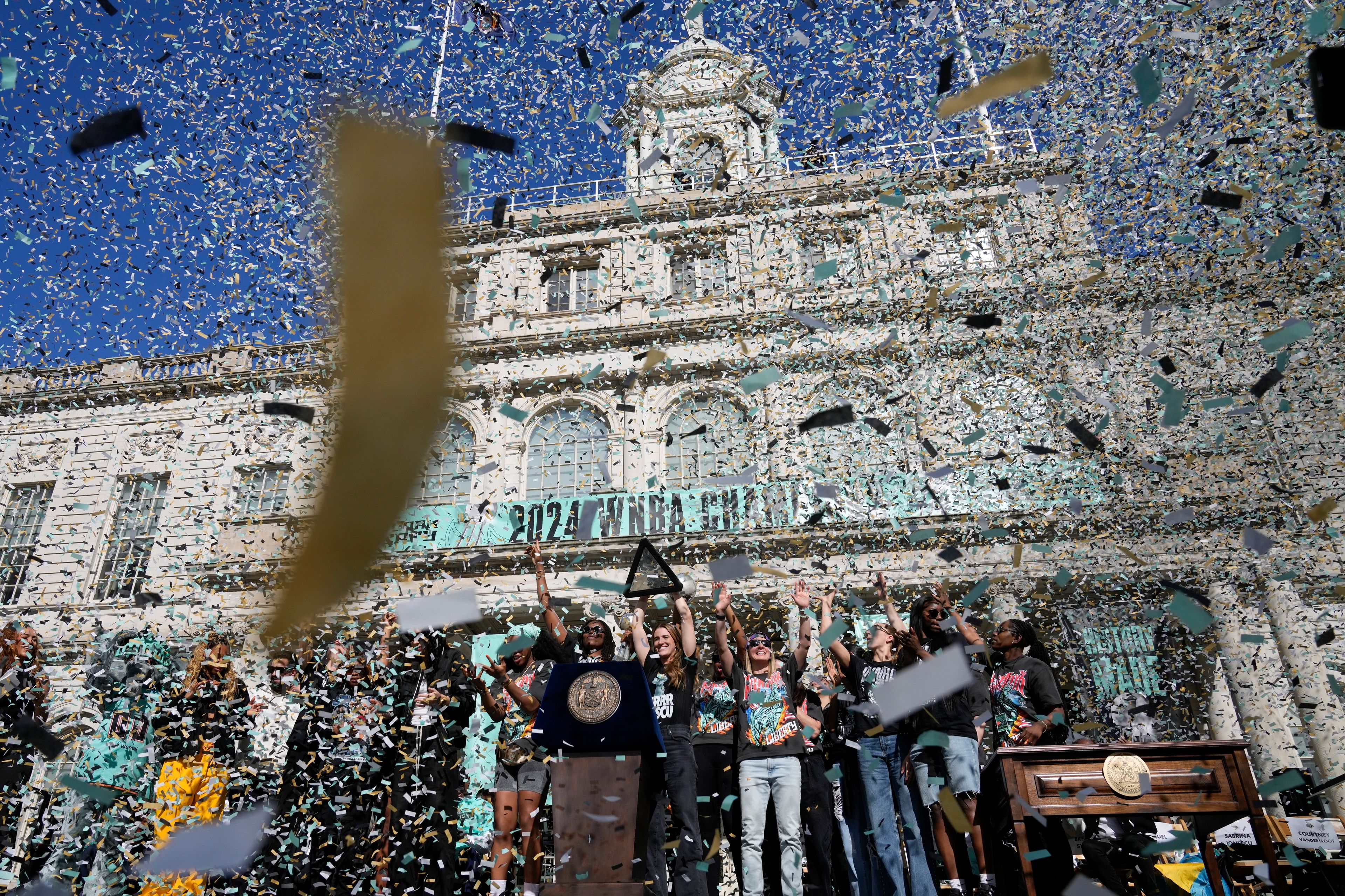 The New York Liberty, their supporters, local officials and others celebrate during a ceremony after a parade in honor of the Liberty's WNBA basketball championship at City Hall in New York, Thursday, Oct. 24, 2024. (AP Photo/Seth Wenig)