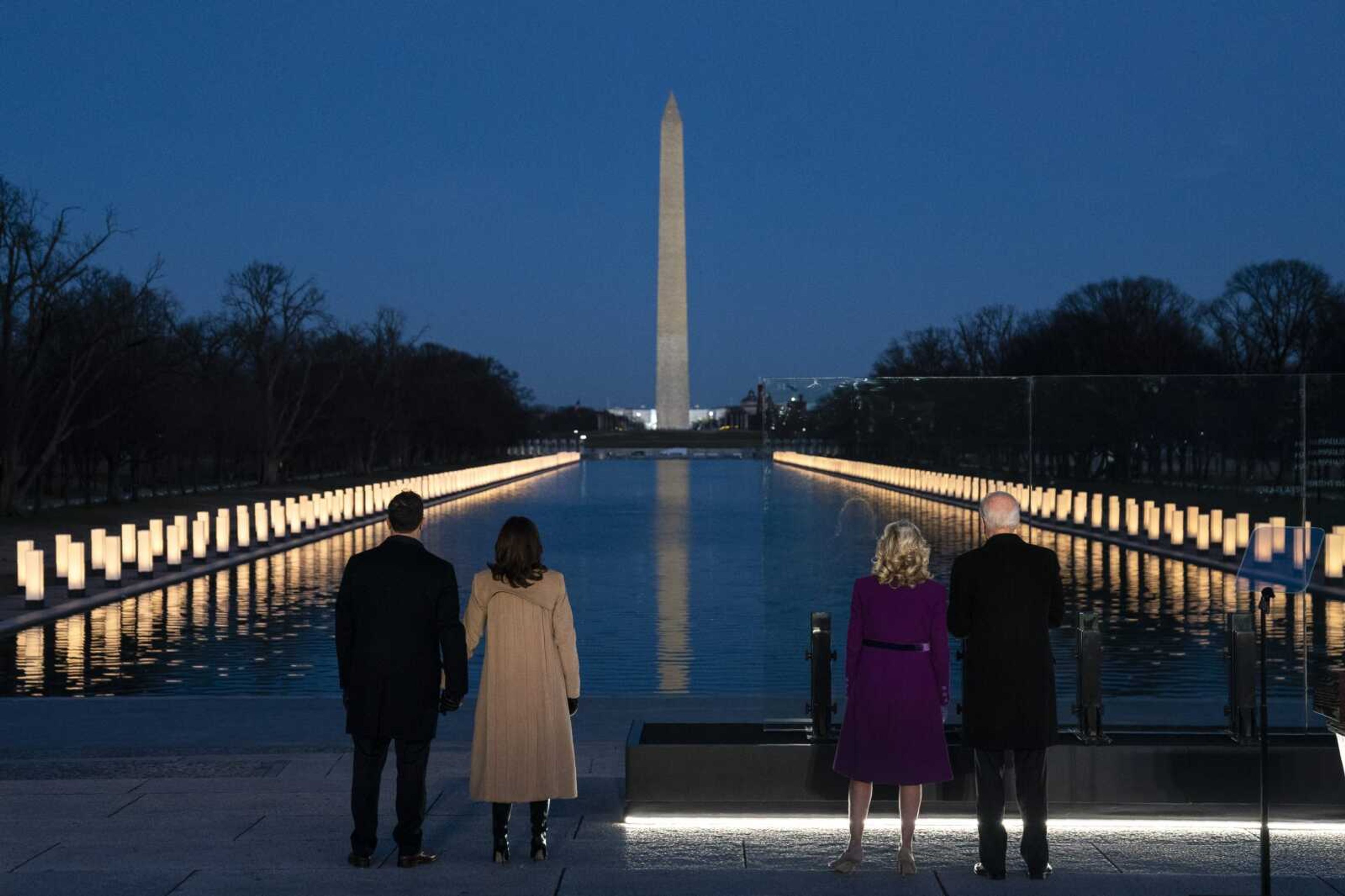 President-elect Joe Biden and his wife Jill Biden (right) are joined by Vice President-elect Kamala Harris and her husband Doug Emhoff (left) to participate in Tuesday's COVID-19 memorial event at the Lincoln Memorial Reflecting Pool in Washington.