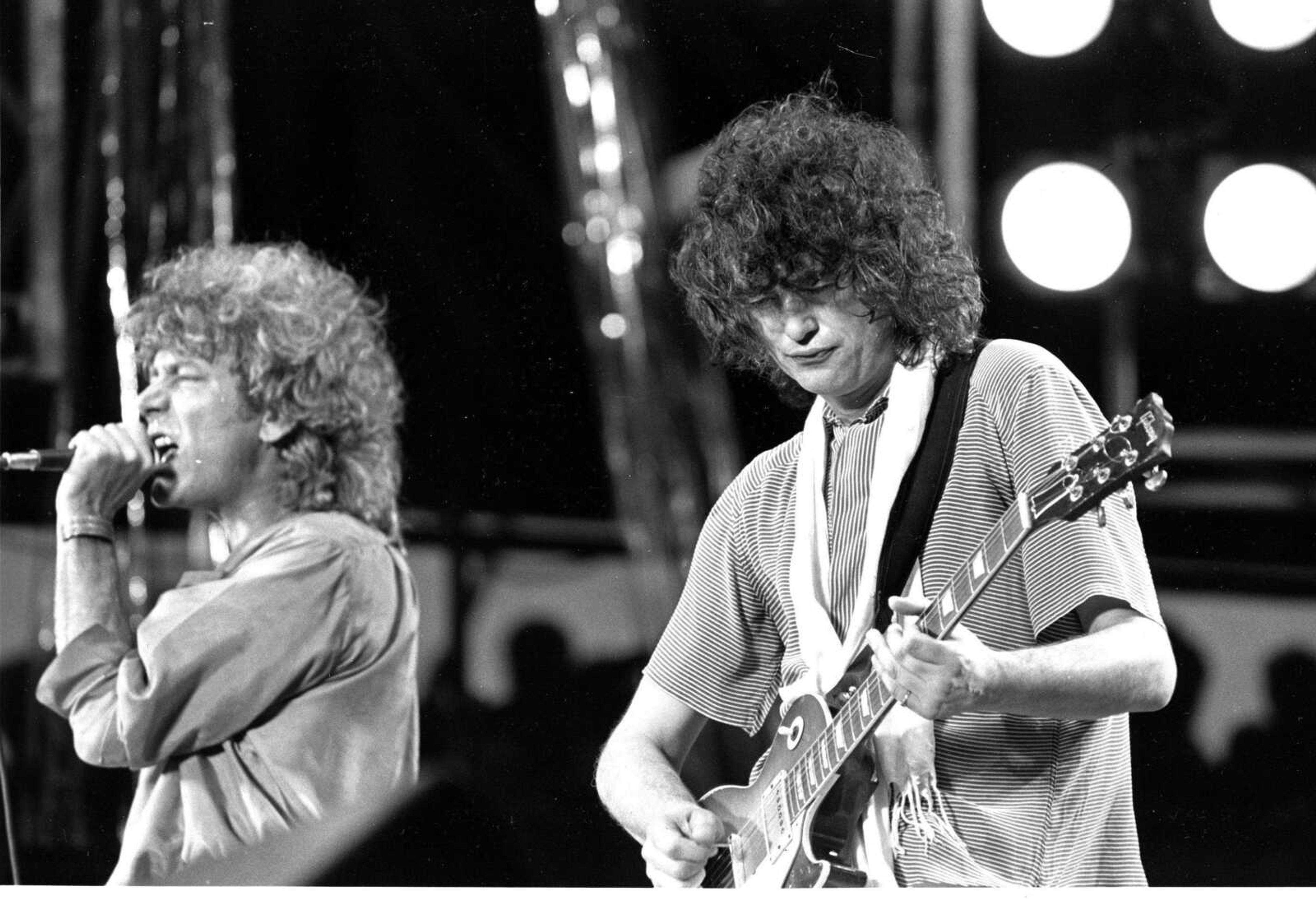 Singer Robert Plant, left, and guitarist Jimmy Page, right, of the British rock band Led Zeppelin perform at the Live Aid concert at Philadelphia's J.F.K. Stadium in this file photo July 13, 1985.  (AP Photo/Rusty Kennedy, file)