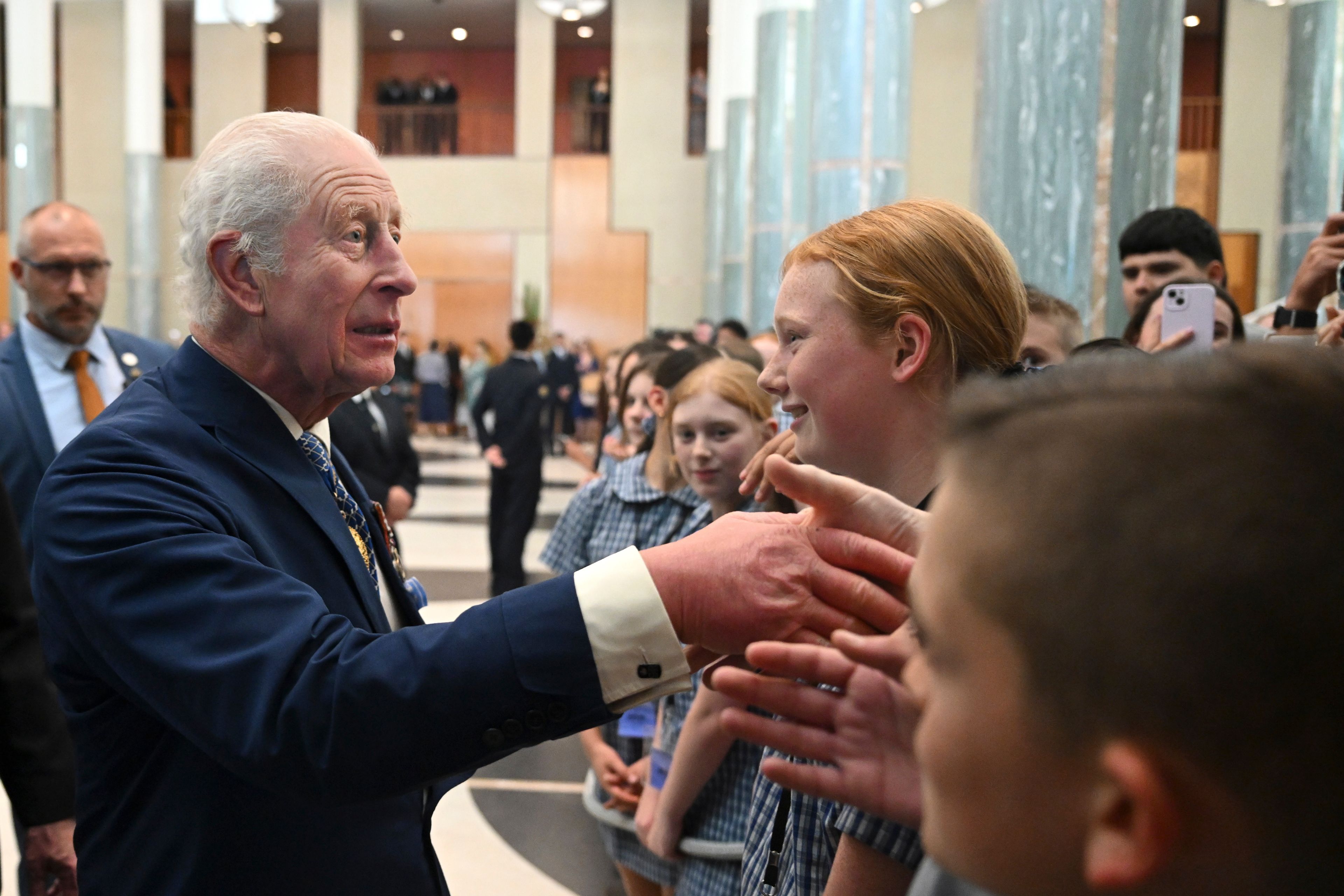 Britain's King Charles III greets students after attending a Parliamentary reception hosted by Australian Prime Minister Anthony Albanese and partner Jodie Jaydon at Parliament House in Canberra, Australia, Monday, Oct. 21, 2024. (Lukas Coch/Pool Photo via AP)