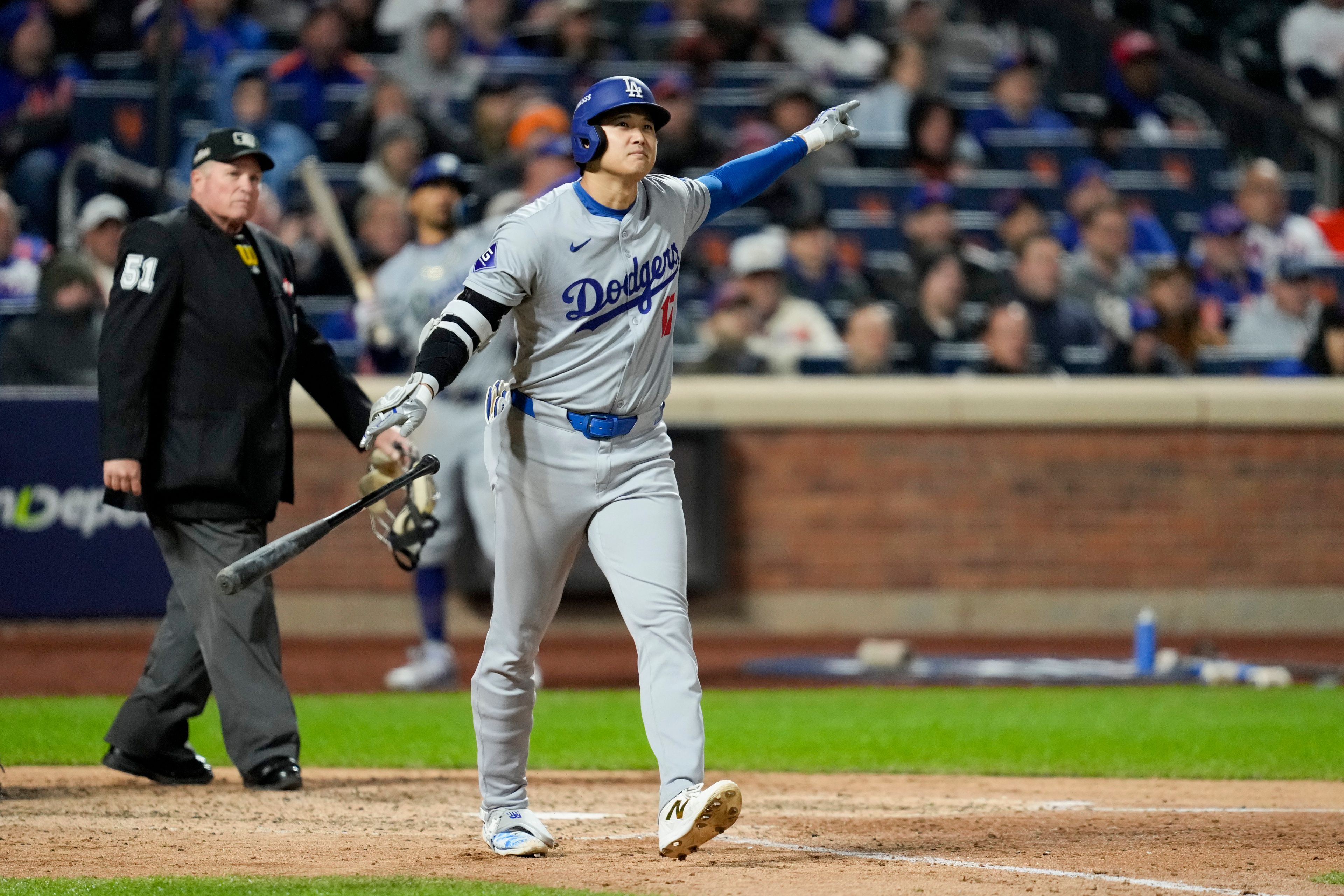 Los Angeles Dodgers' Shohei Ohtani celebrates his three-run home run against the New York Mets during the eighth inning in Game 3 of a baseball NL Championship Series, Wednesday, Oct. 16, 2024, in New York. (AP Photo/Ashley Landis)