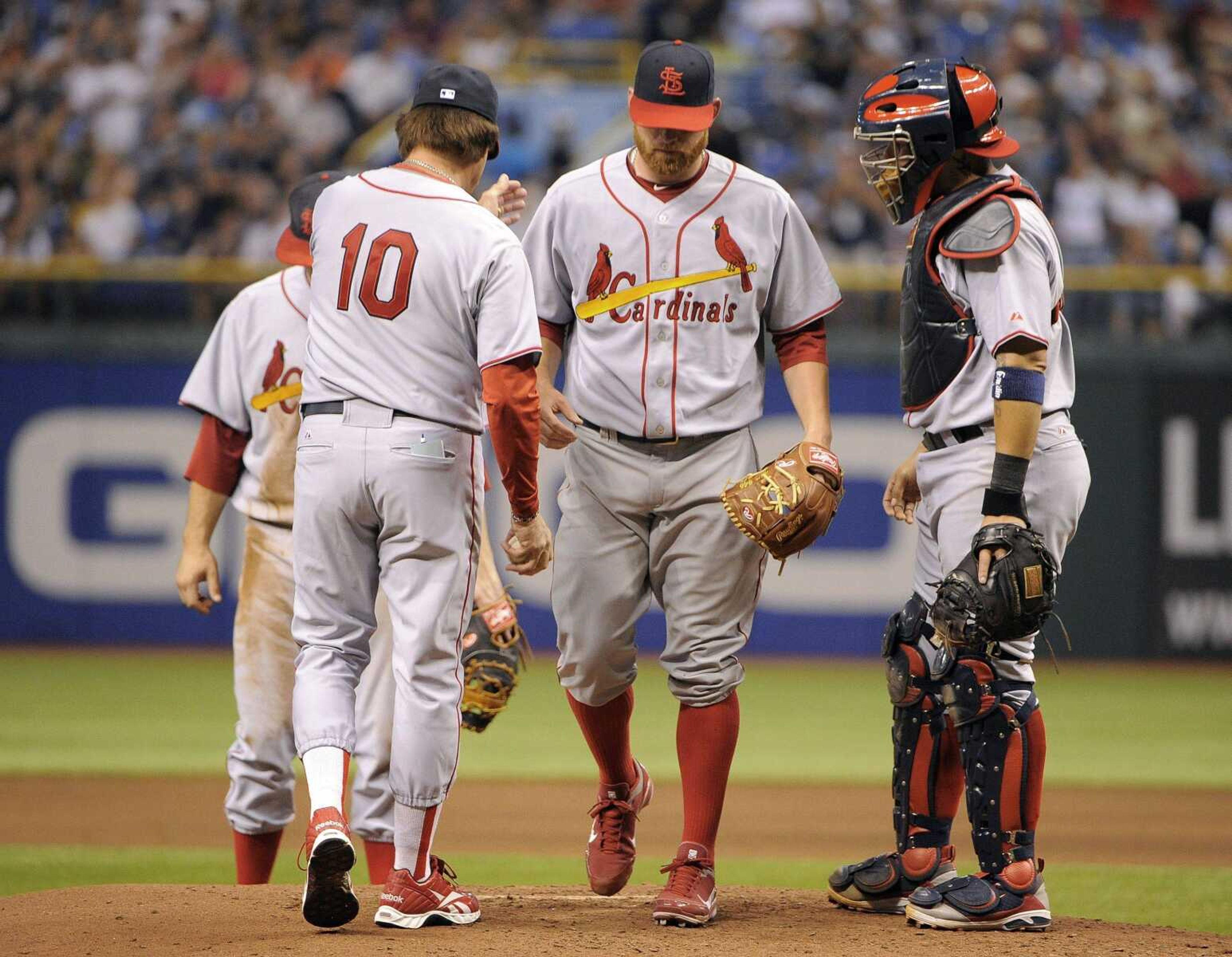 Cardinals starting pitcher Kyle McClellan is taken out of the game by manager Tony La Russa (10) as catcher Yadier Molina looks on during the sixth inning Saturday in St. Petersburg, Fla. The Rays scored five runs in the inning and went on to a 5-1 victory. (Brian Blanco ~ Associated Press)