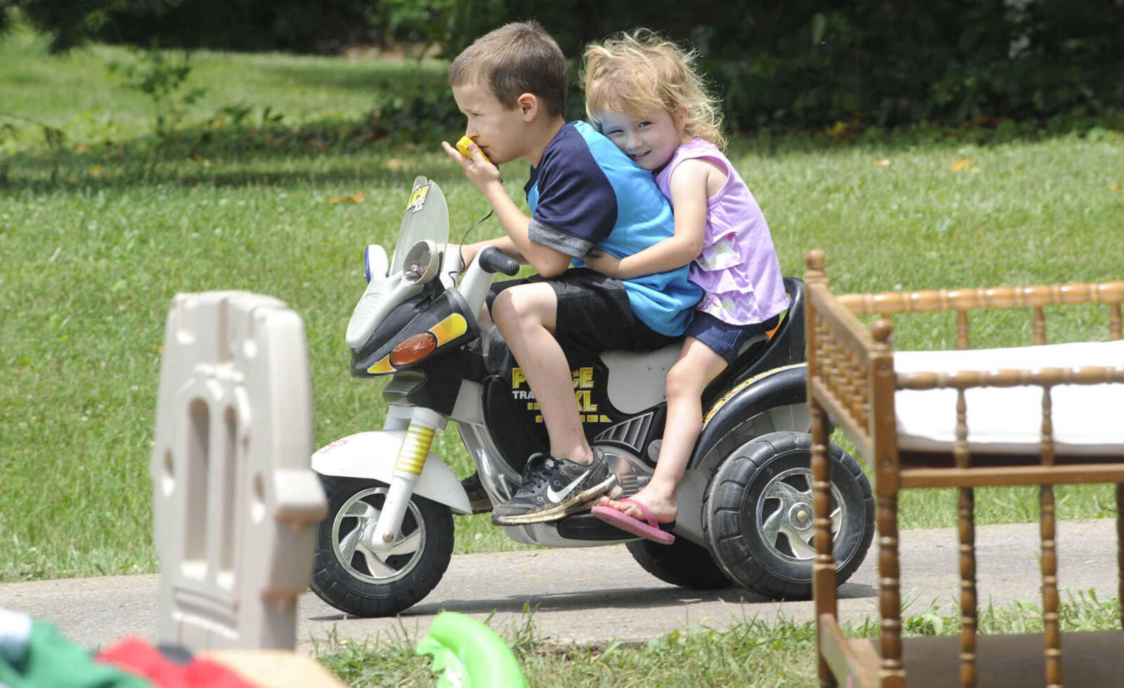 FRED LYNCH ~ flynch@semissourian.com
Dylan Huffman and his sister, Baylie Huffman, try out the new wheels they would take home after shopping along the 100-Mile Yard Sale on Saturday, May 28, 2016 near Jackson.