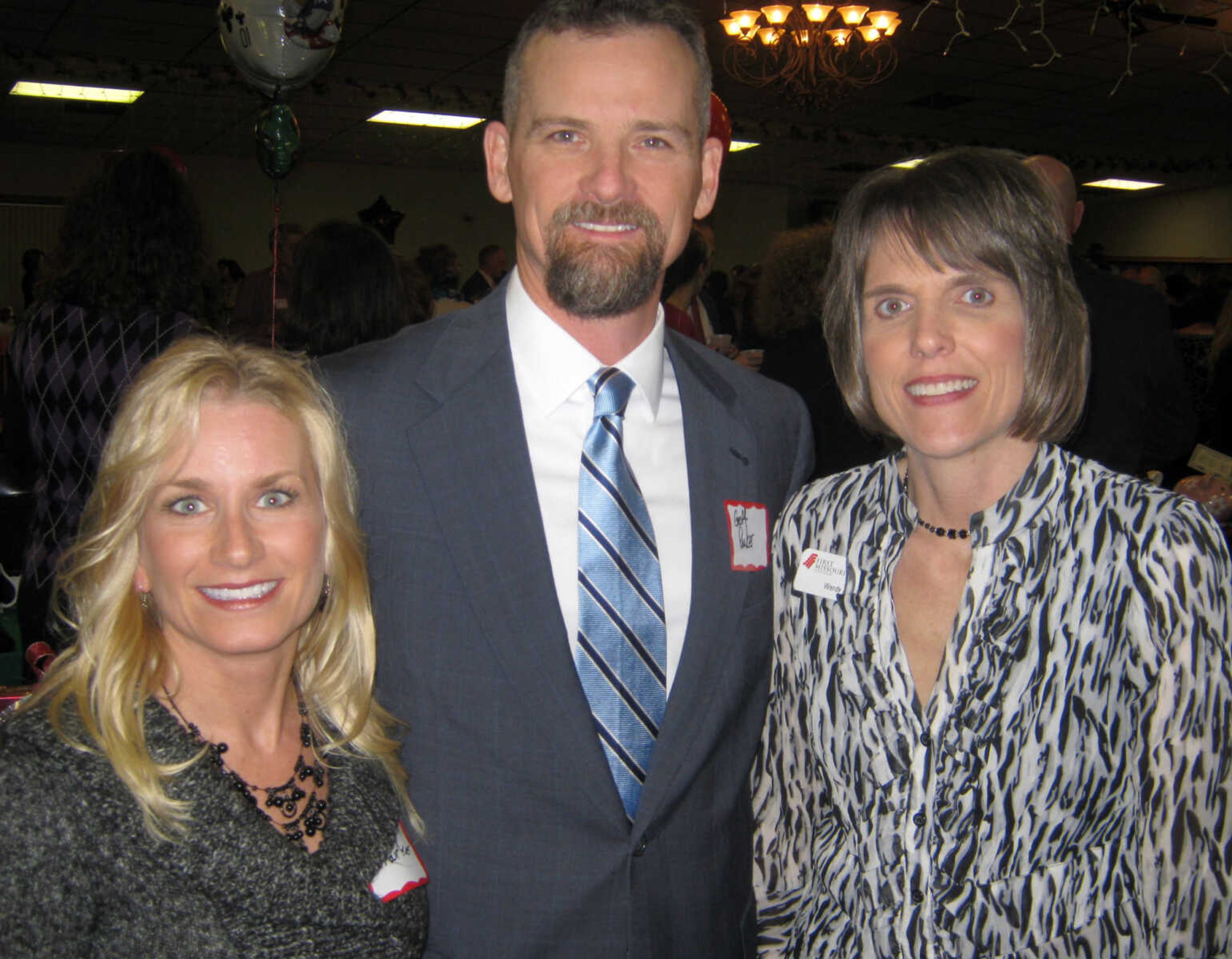 Christy Parker, First Missouri State Bank, left; Geoff Parker, First Missouri State Bank; and Wendy Aufdenberg, First Missouri State Bank, pose at the Jackson Area Chamber of Commerce annual awards banquet, Jan. 11, at the the Knights of Columbus Hall in Jackson, Mo.