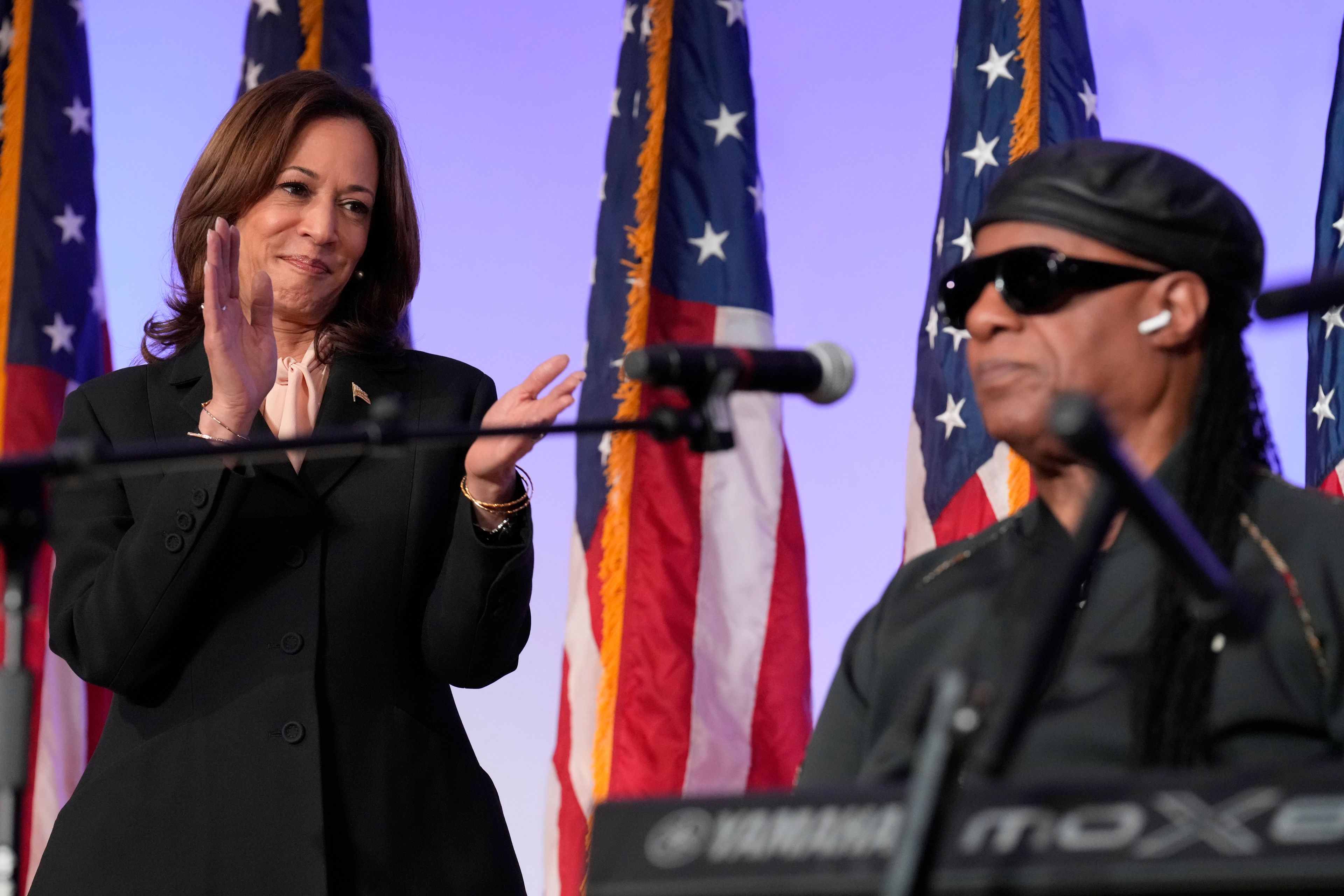 Democratic presidential nominee Vice President Kamala Harris claps after Stevie Wonder sang "Happy Birthday" to Harris during a church service and early vote event at Divine Faith Ministries International, Sunday, Oct. 20, 2024, in Jonesboro, Ga. (AP Photo/Jacquelyn Martin)