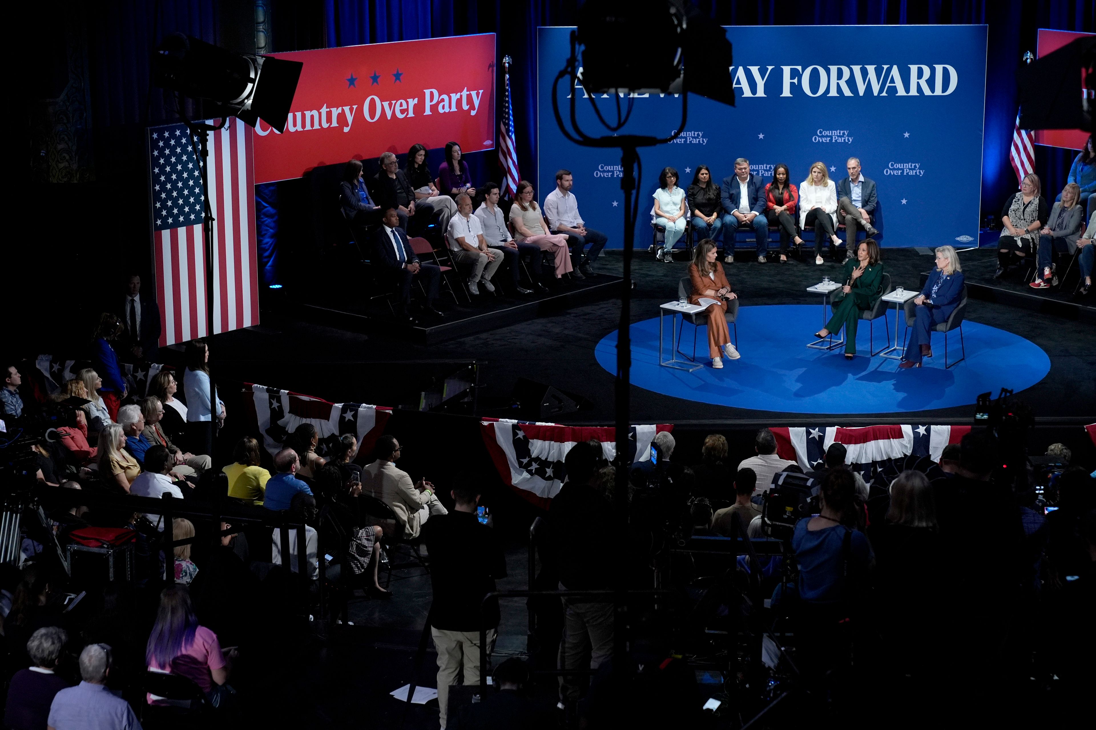 Moderator Maria Shriver, from left, Democratic presidential nominee Vice President Kamala Harris and former Republican Congresswoman Liz Cheney participate in a town hall at the Royal Oak Theatre in Royal Oak, Mich., Monday, Oct. 21, 2024. (AP Photo/Jacquelyn Martin)