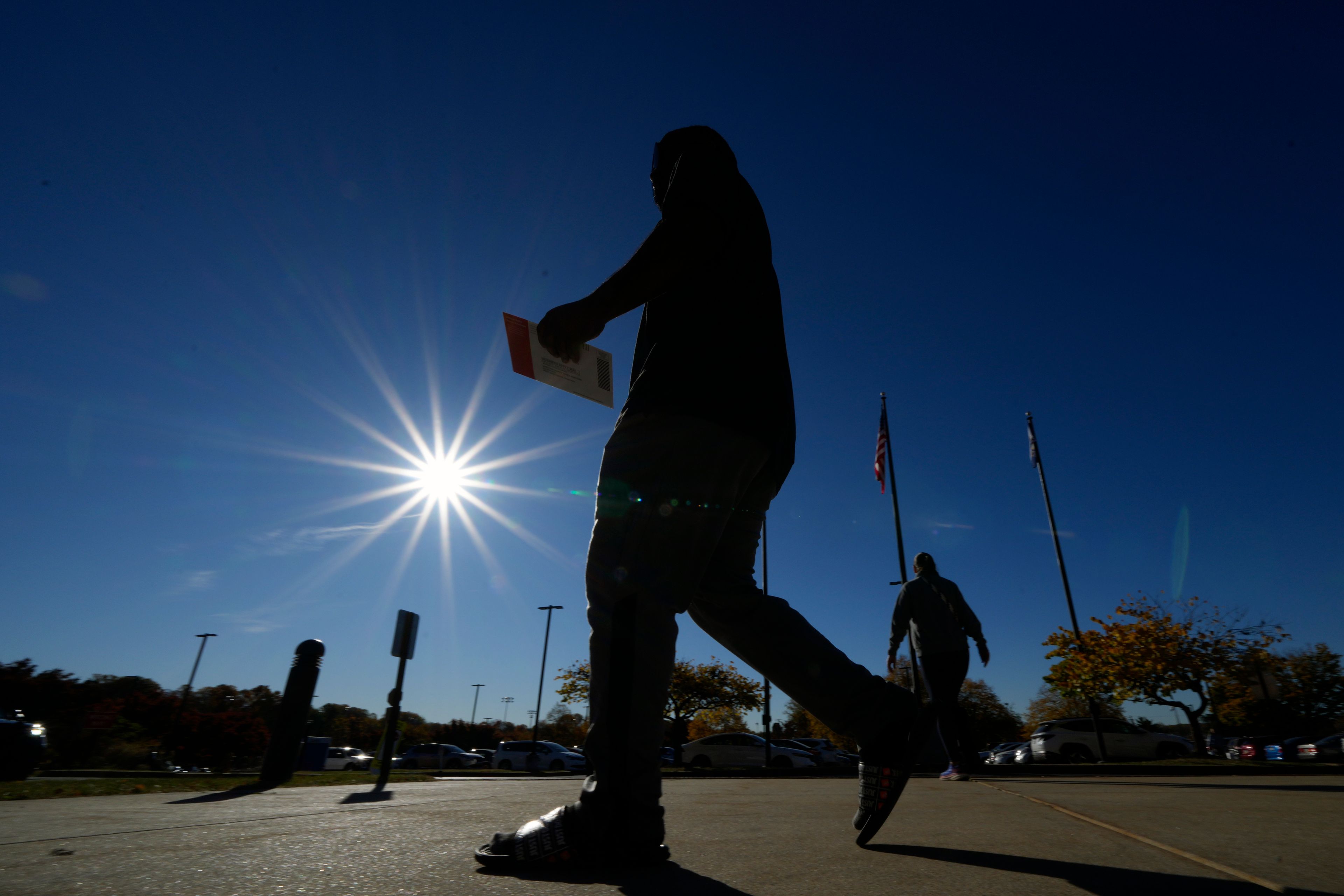 A voter returns their mail-in ballot for the 2024 General Election in the United States outside the Chester County Government Services Center, Friday, Oct. 25, 2024, in West Chester, Pa. (AP Photo/Matt Slocum)