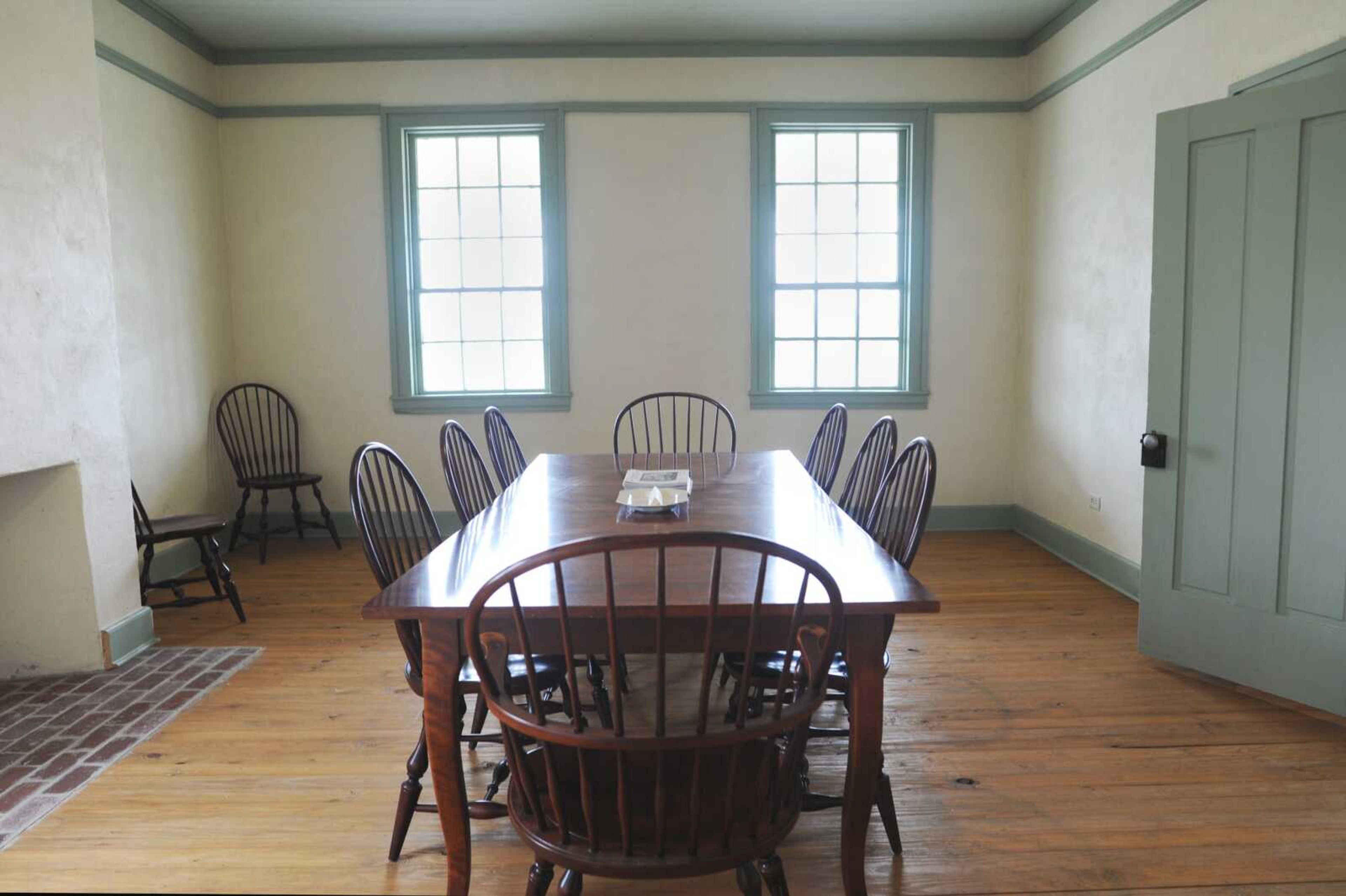 A colonial-style dining table with matching chairs sits in one of the front rooms of the James Reynolds House. In furnishing the house, Laurie Everett said she wanted to keep design elements simple, so the space "can be transformed for different events."