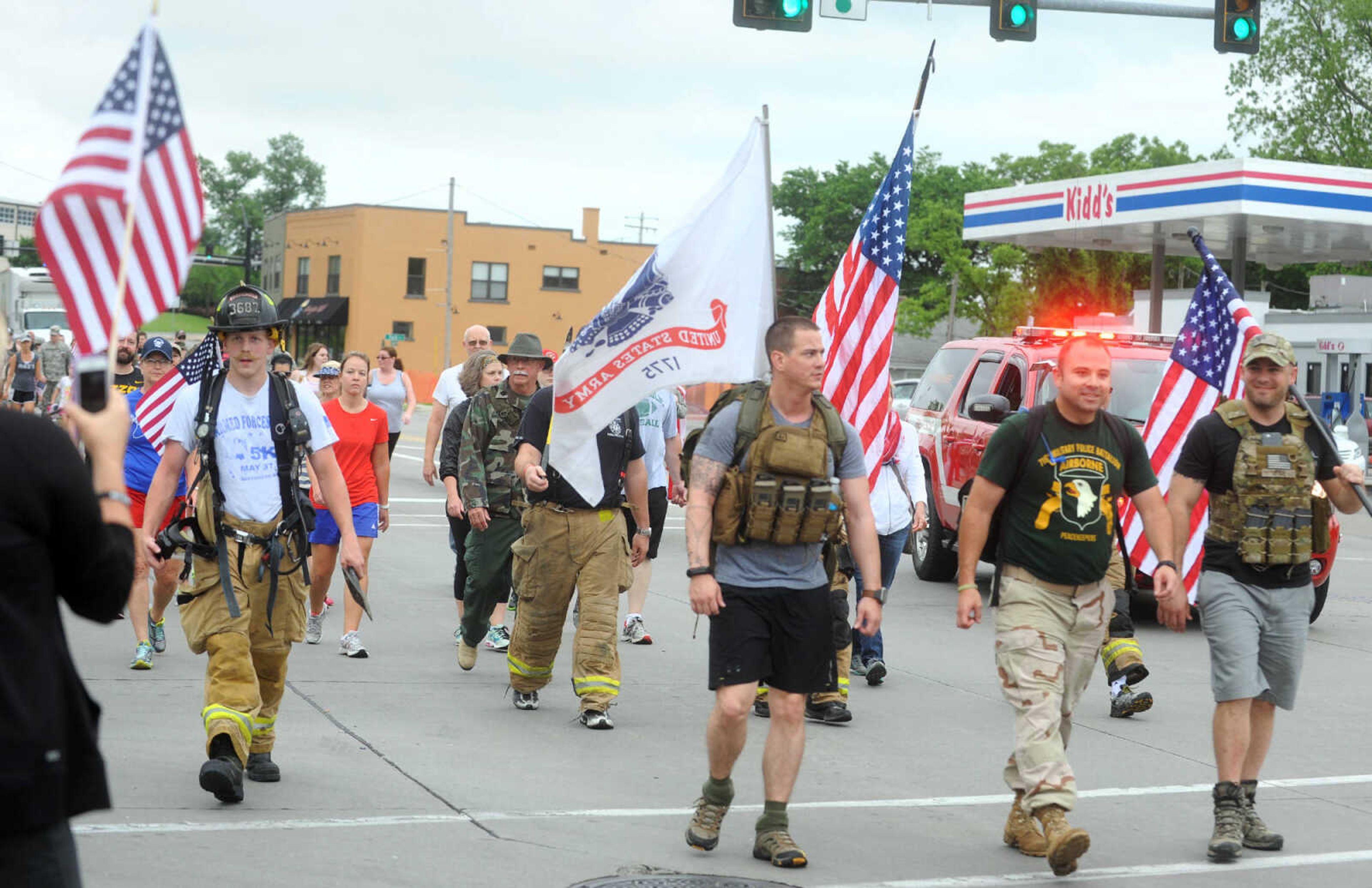 LAURA SIMON ~ lsimon@semissourian.com

Participants in the first ever Carry the Load event walk west on Broadway, Monday, May 25, 2015, in Cape Girardeau.