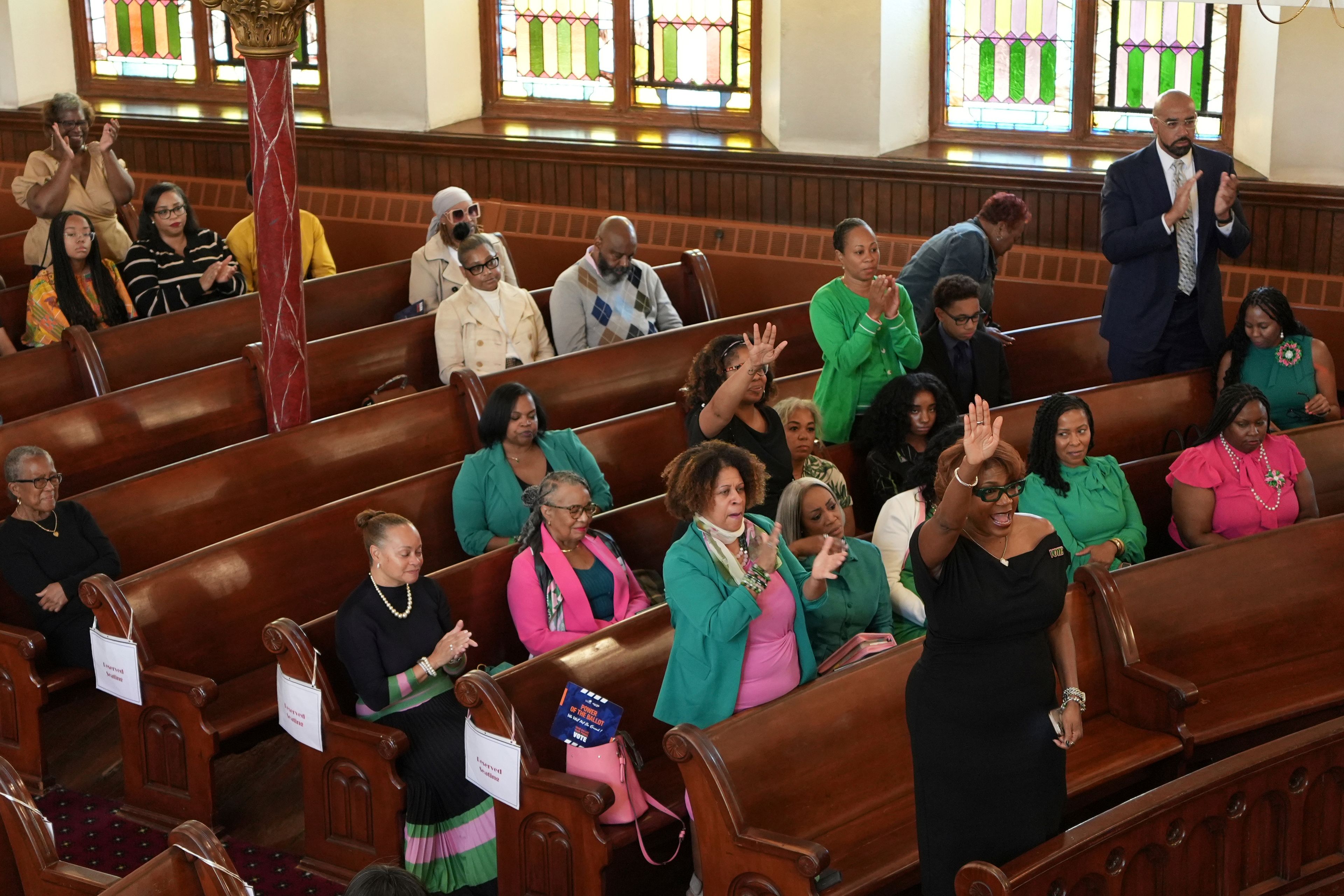 Mother Bethel AME First Lady Leslie Tyler, front pew, worships with congregants and members of the Alpha Kappa Sorority at a service in Philadelphia on Sunday, Oct. 13, 2024. (AP Photo/Luis Andres Henao)