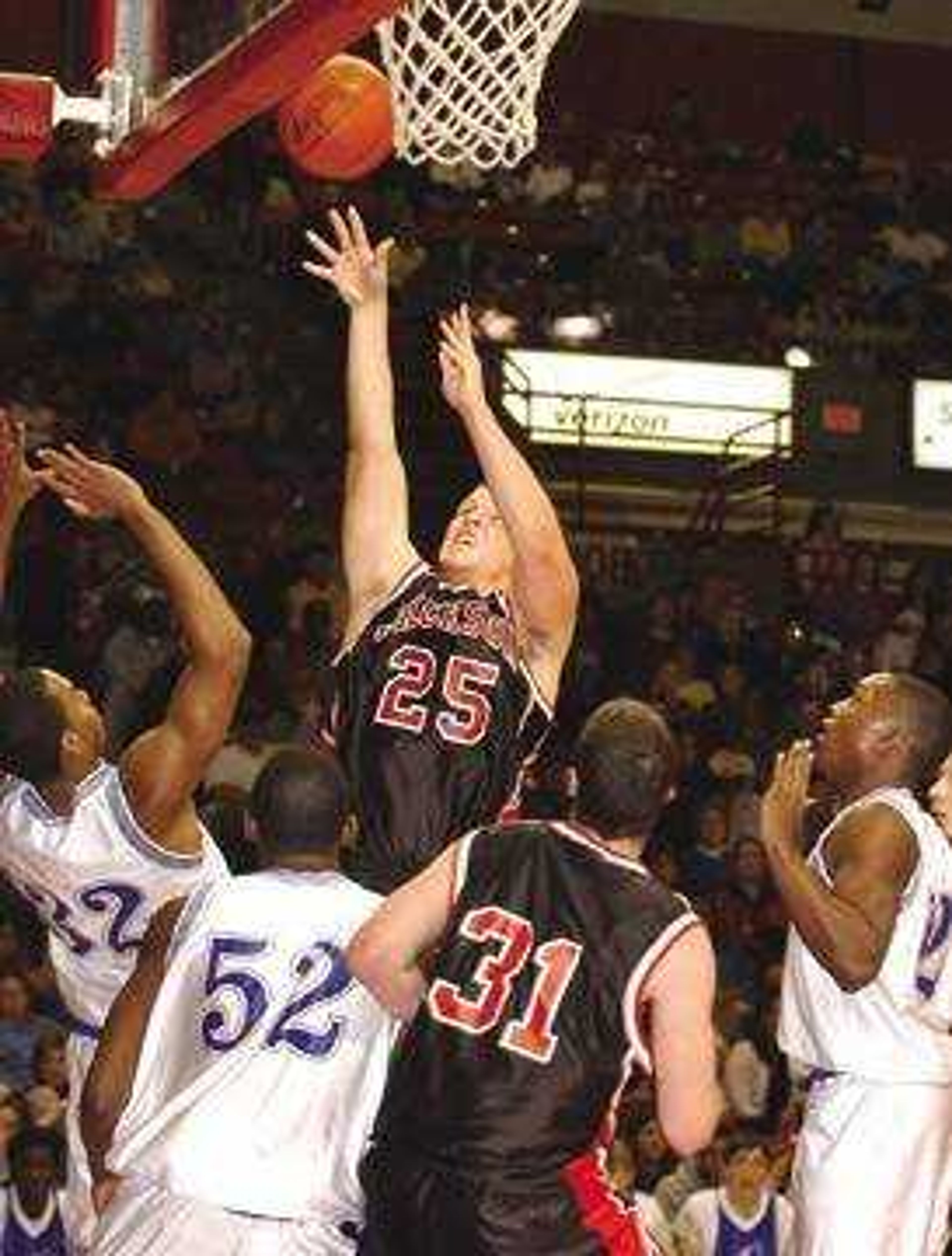 Jackson's Tyler McNeely shot for a basket over Charleston's Ashton Farmer (32) and Jamarcus Williams (52) during the first half of Monday's, December 29, 2003, semifinal game of the seMissourian Christmas Tournament played at the Show Me Center.