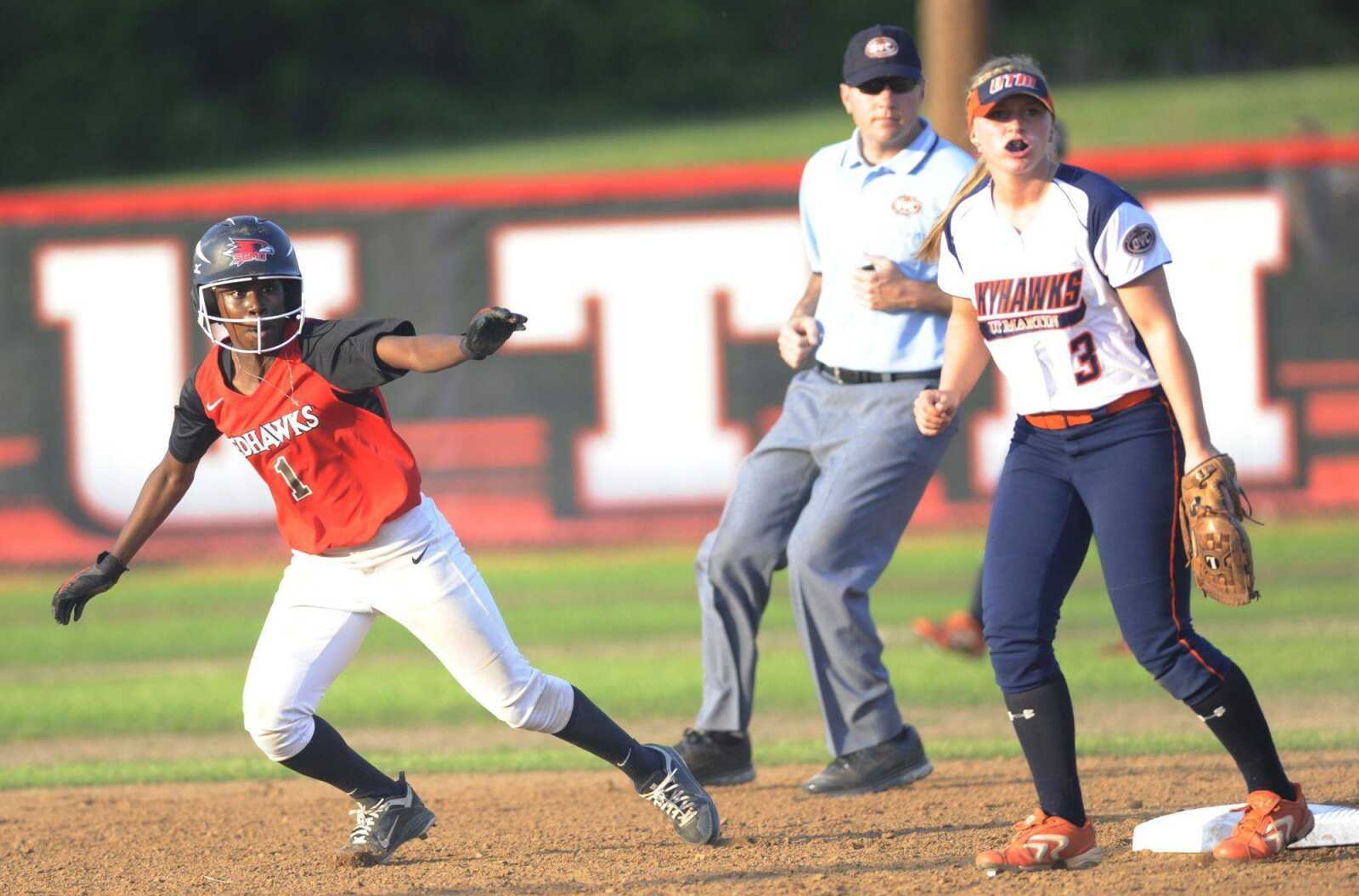 ABOVE: Tennessee Martin&#8217;s Samantha McClure looks on as Southeast Missouri State&#8217;s Evan Sallis takes off from second base during the Redhawks&#8217; 3-2 loss Thursday at the Southeast Softball Complex.LEFT: Southeast Missouri State pitcher Alora Marble throws out a batter at first base.ADAM VOGLER avogler@semissourian.com